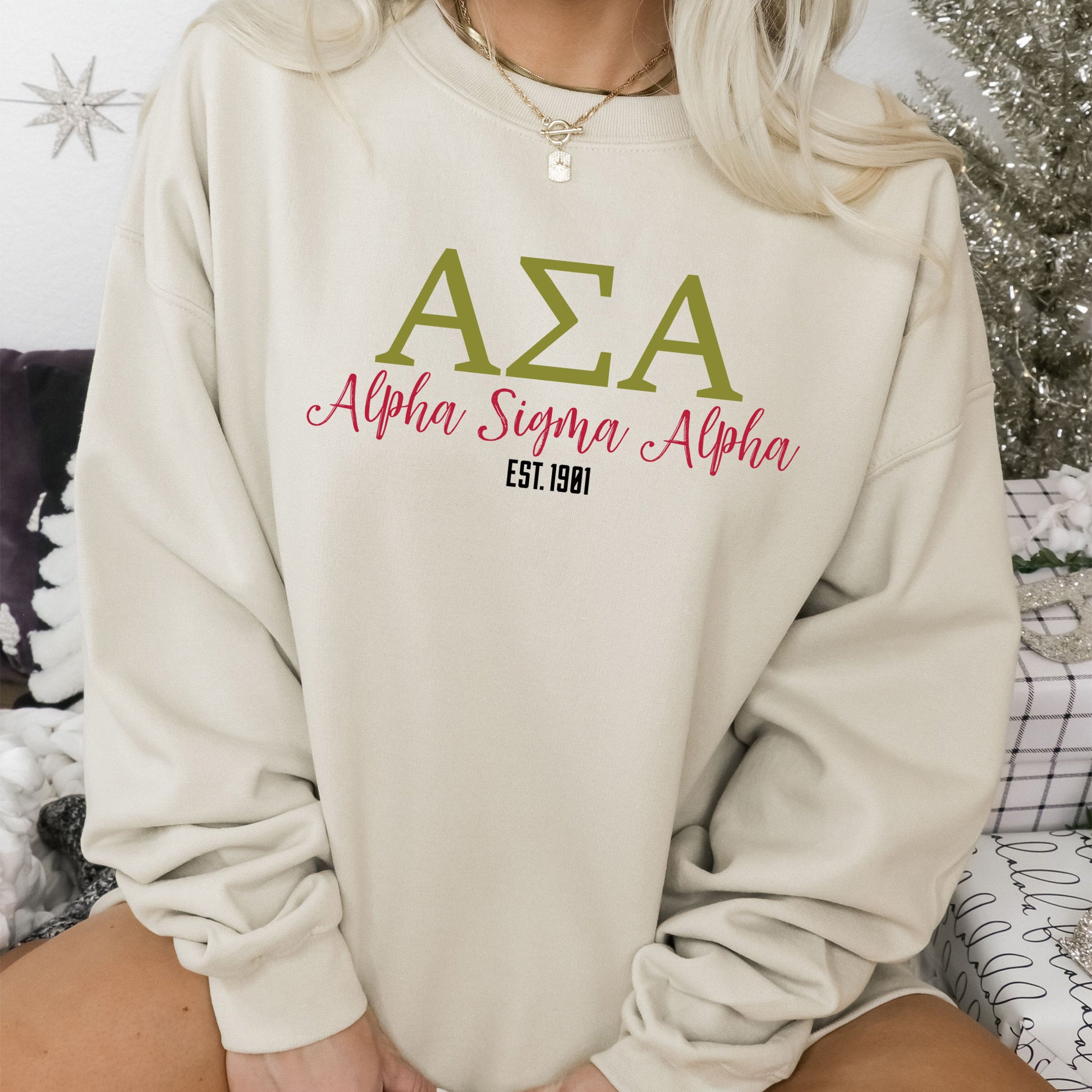 a woman sitting on a bed wearing a sweater