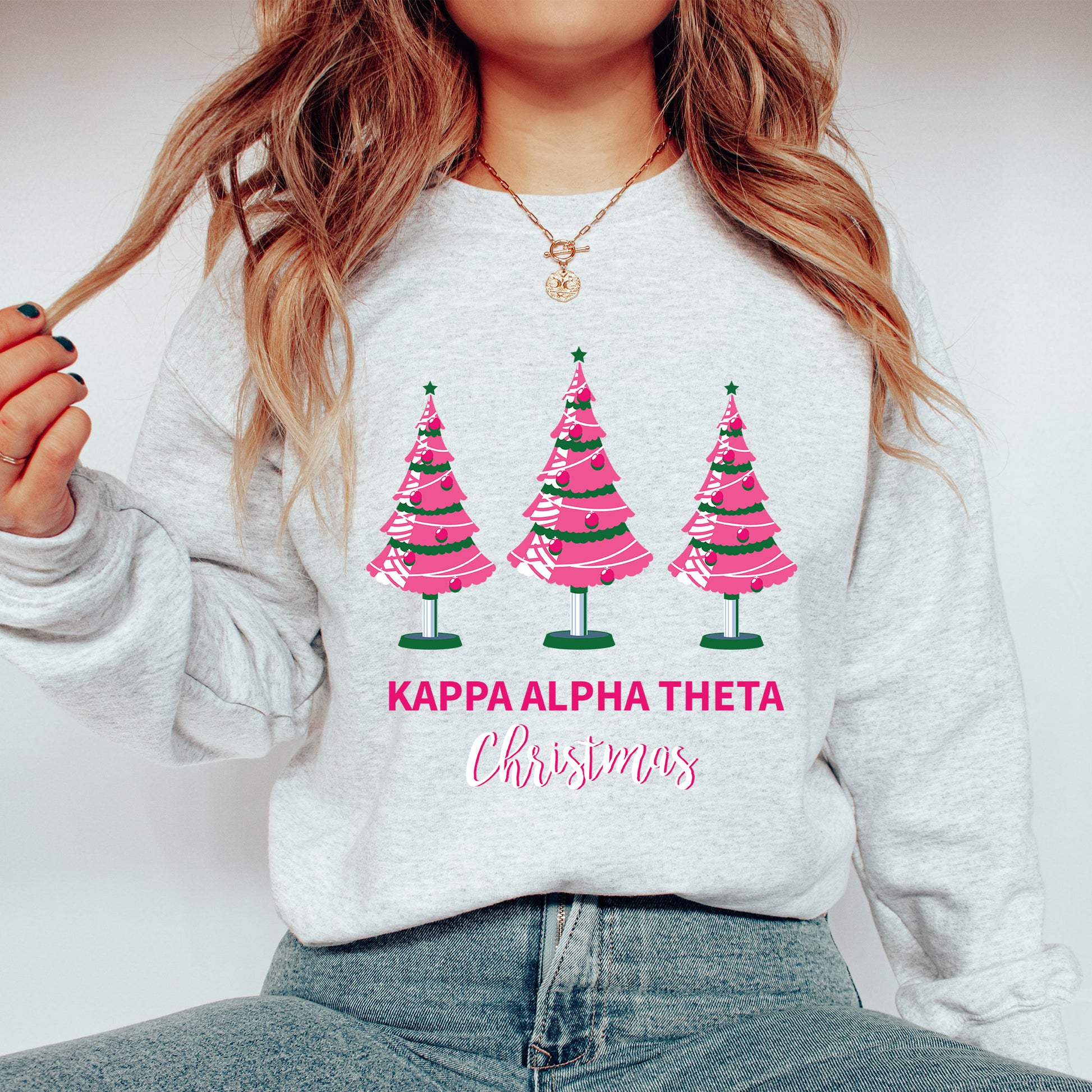 a woman wearing a sweatshirt with christmas trees on it