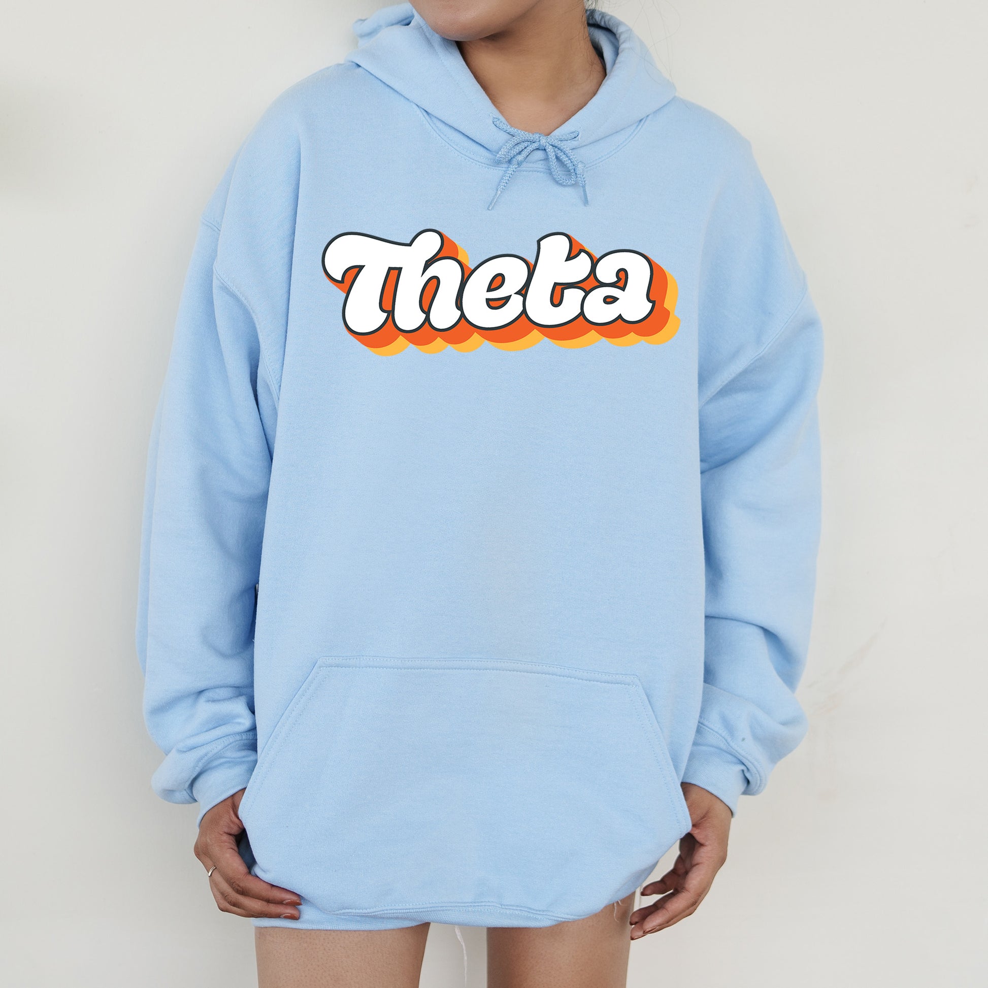 a person wearing a blue hoodie with the word thea on it