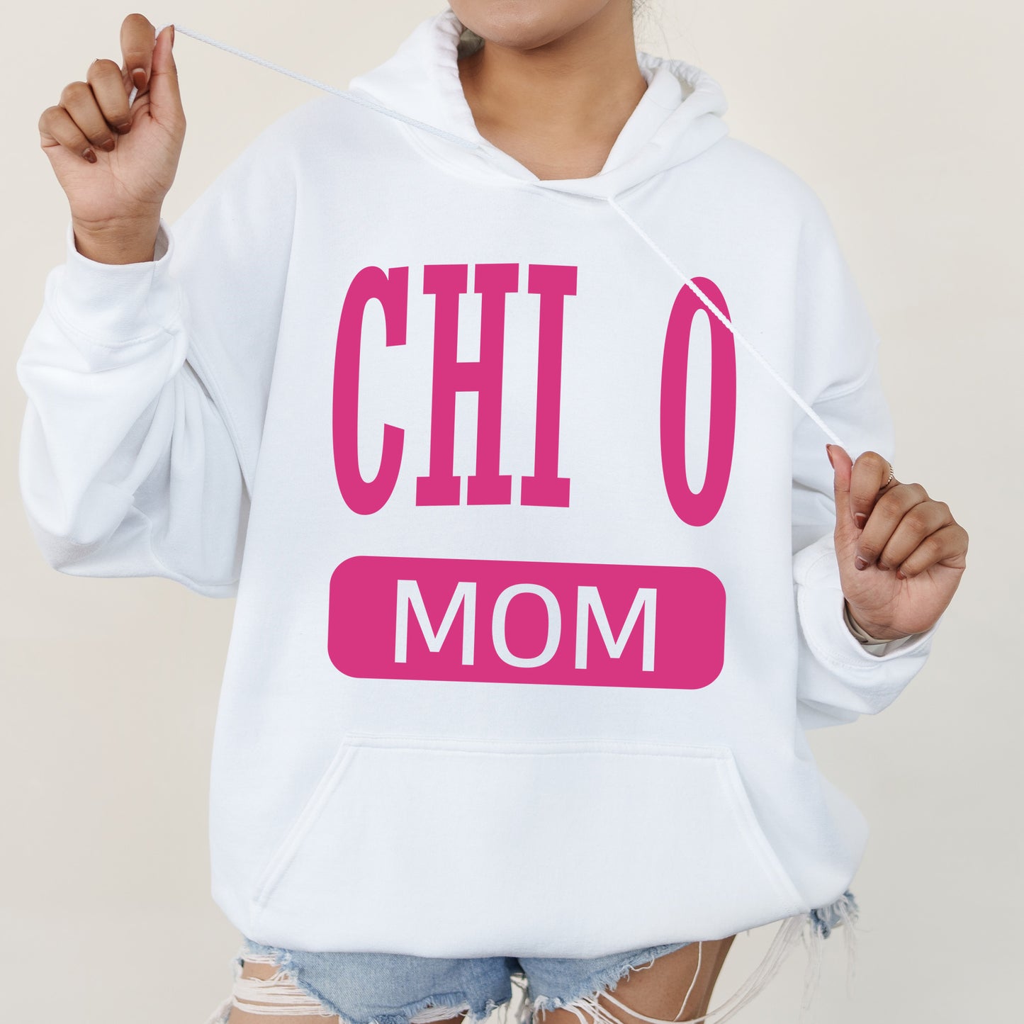 a woman wearing a white hoodie with pink letters on it