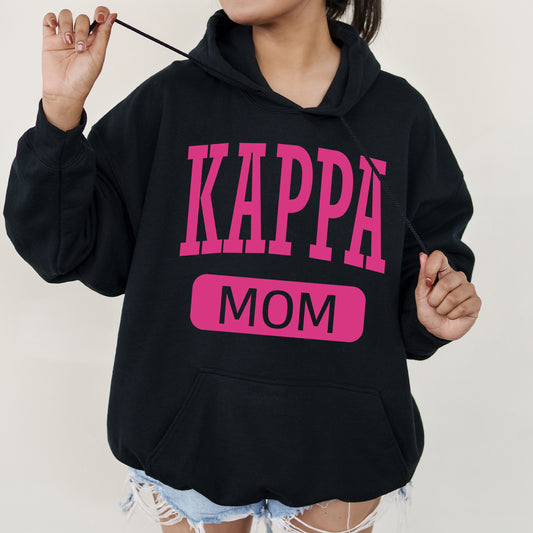 a woman in a black hoodie with pink letters on it