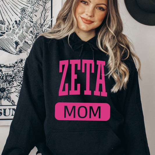 a woman wearing a zeta mom hoodie