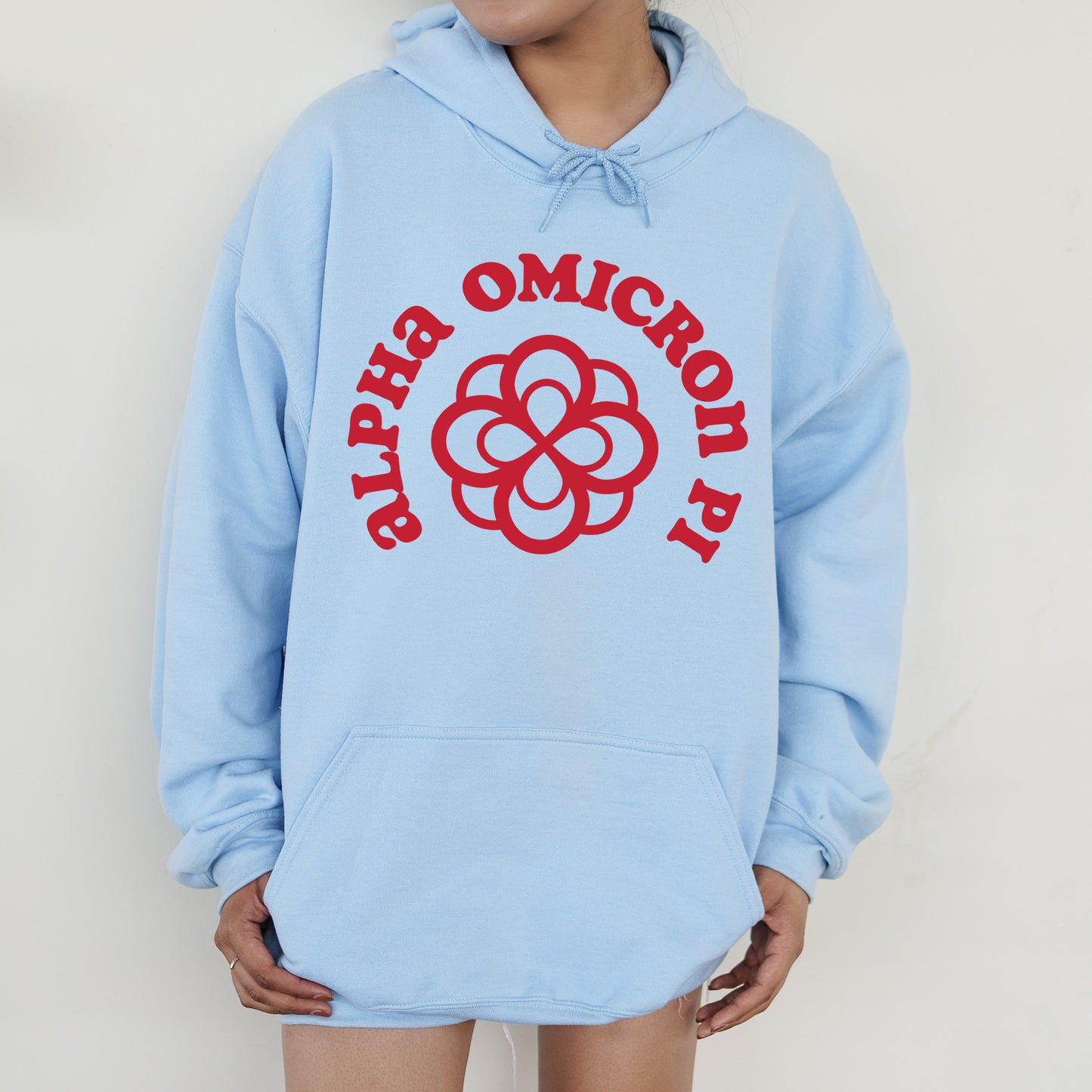 a person wearing a blue hoodie with a red logo on it