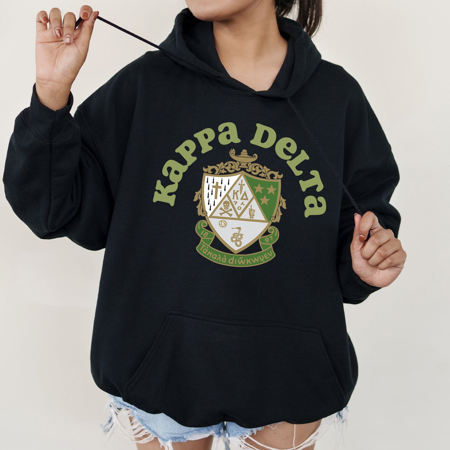 a girl in a black hoodie holding a toothbrush