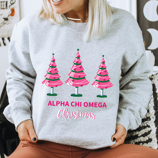 a woman wearing a sweatshirt with christmas trees on it