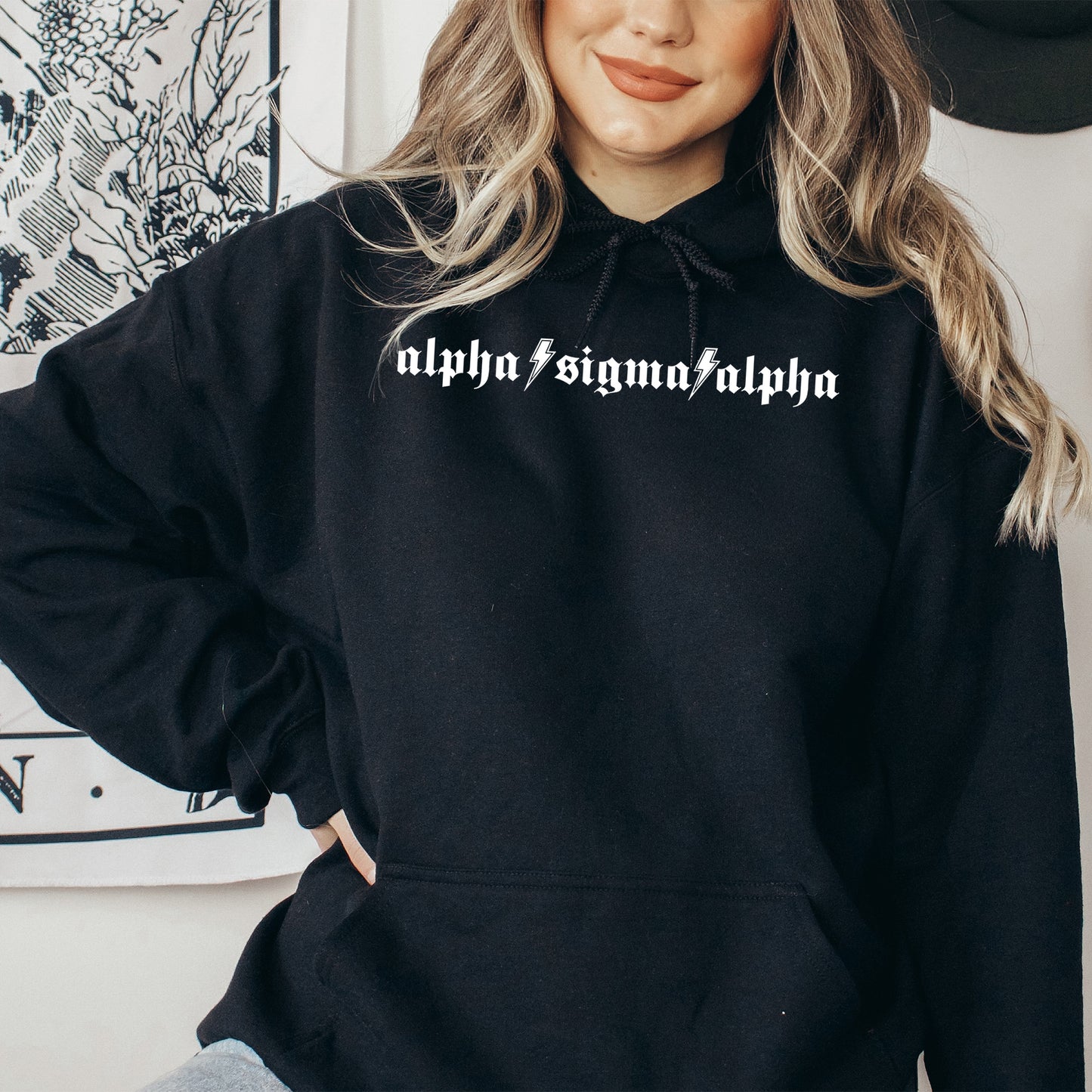 a woman wearing a black hoodie with white writing on it