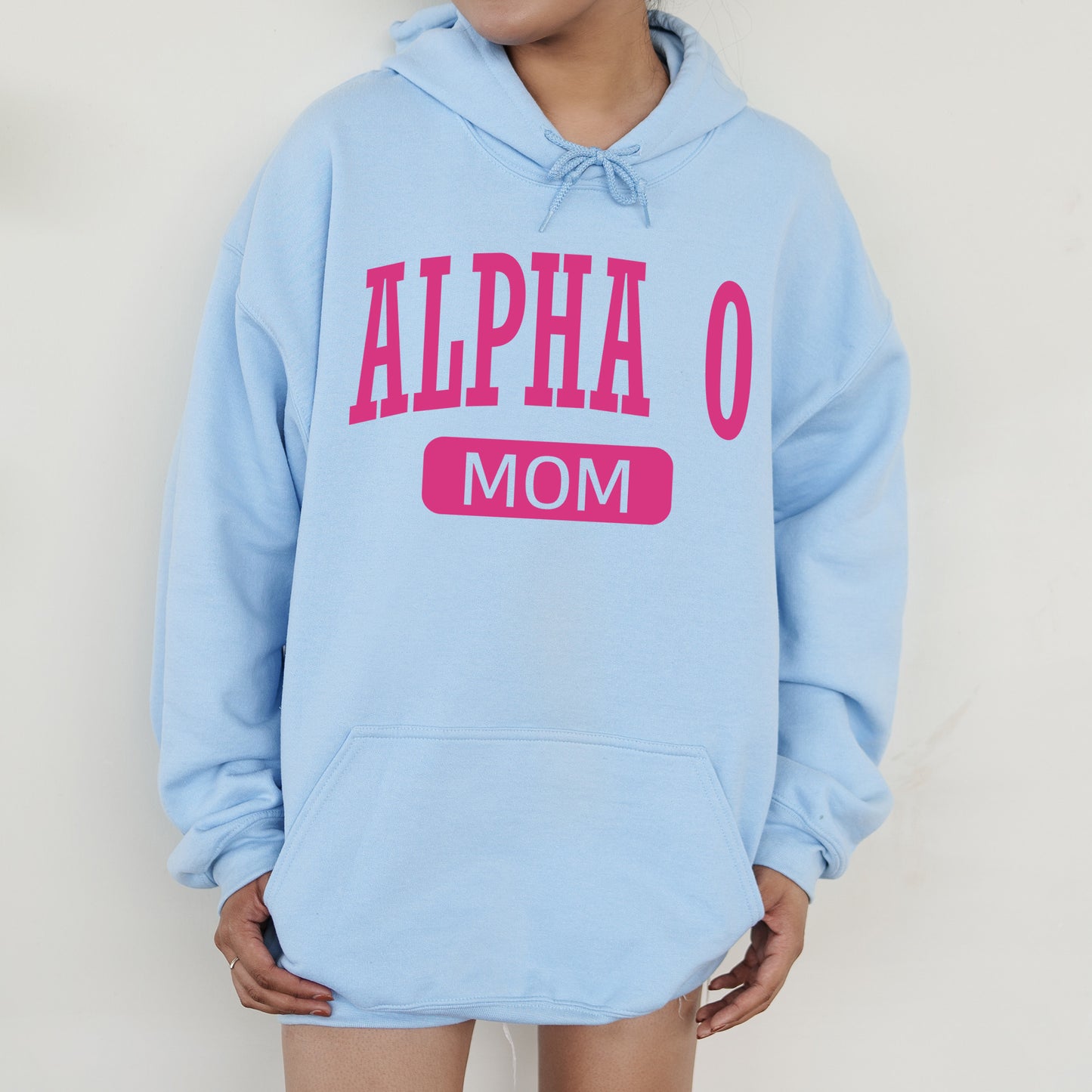 a woman wearing a blue hoodie that says,'alpha o mom '
