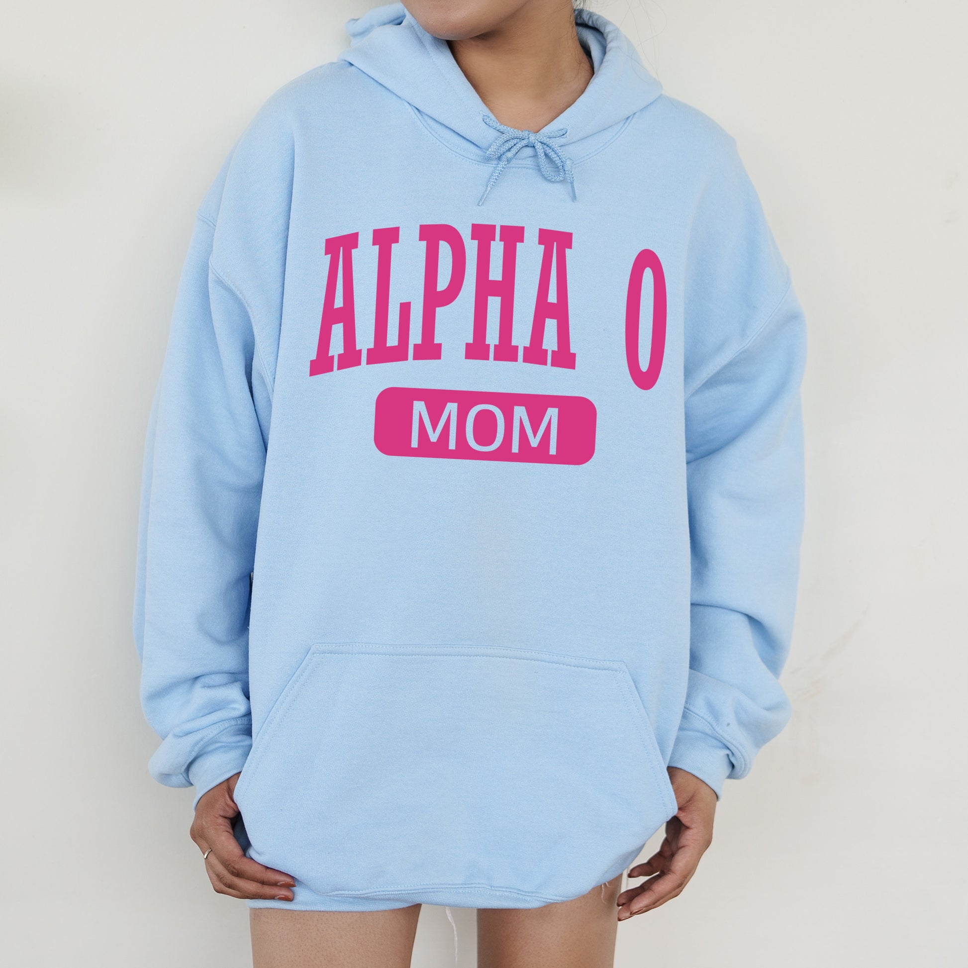a woman wearing a blue hoodie that says,'alpha o mom '