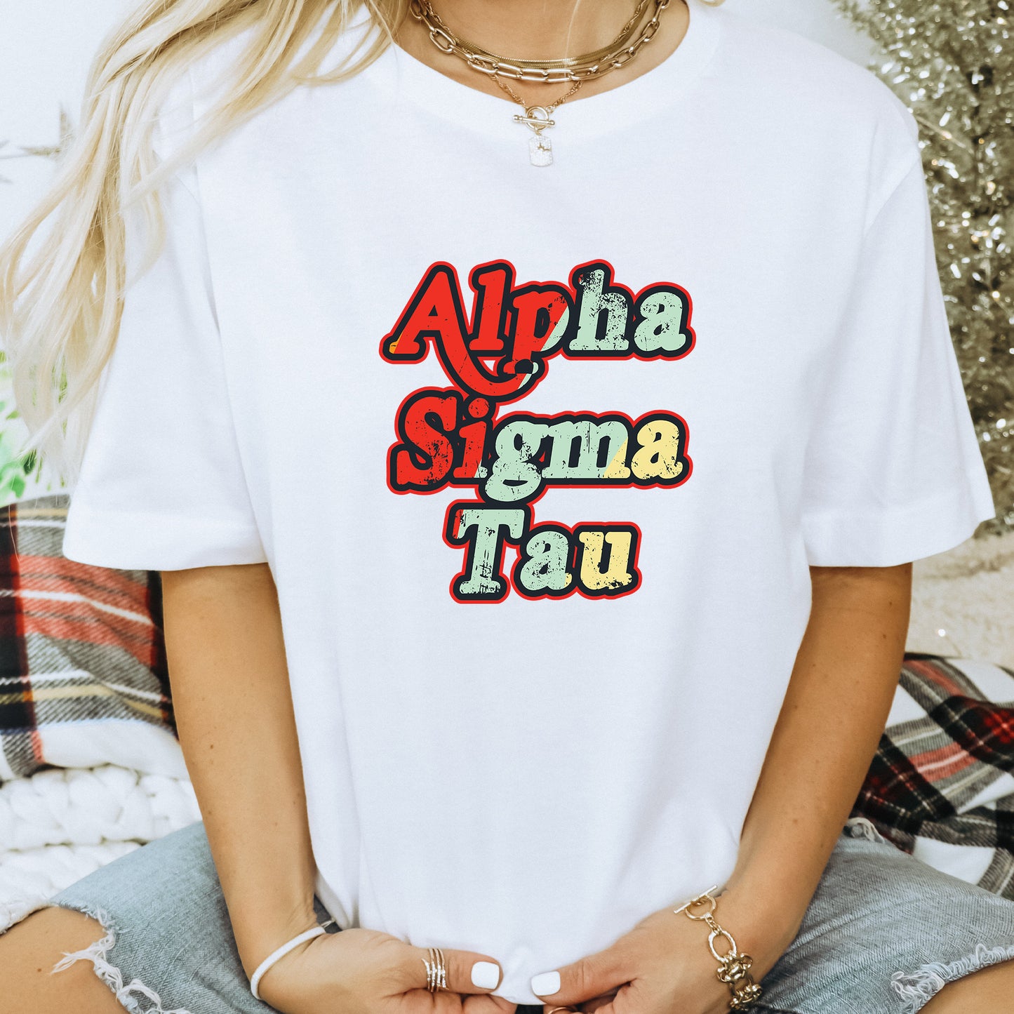 a woman wearing a white t - shirt with the words aloha stigma tau