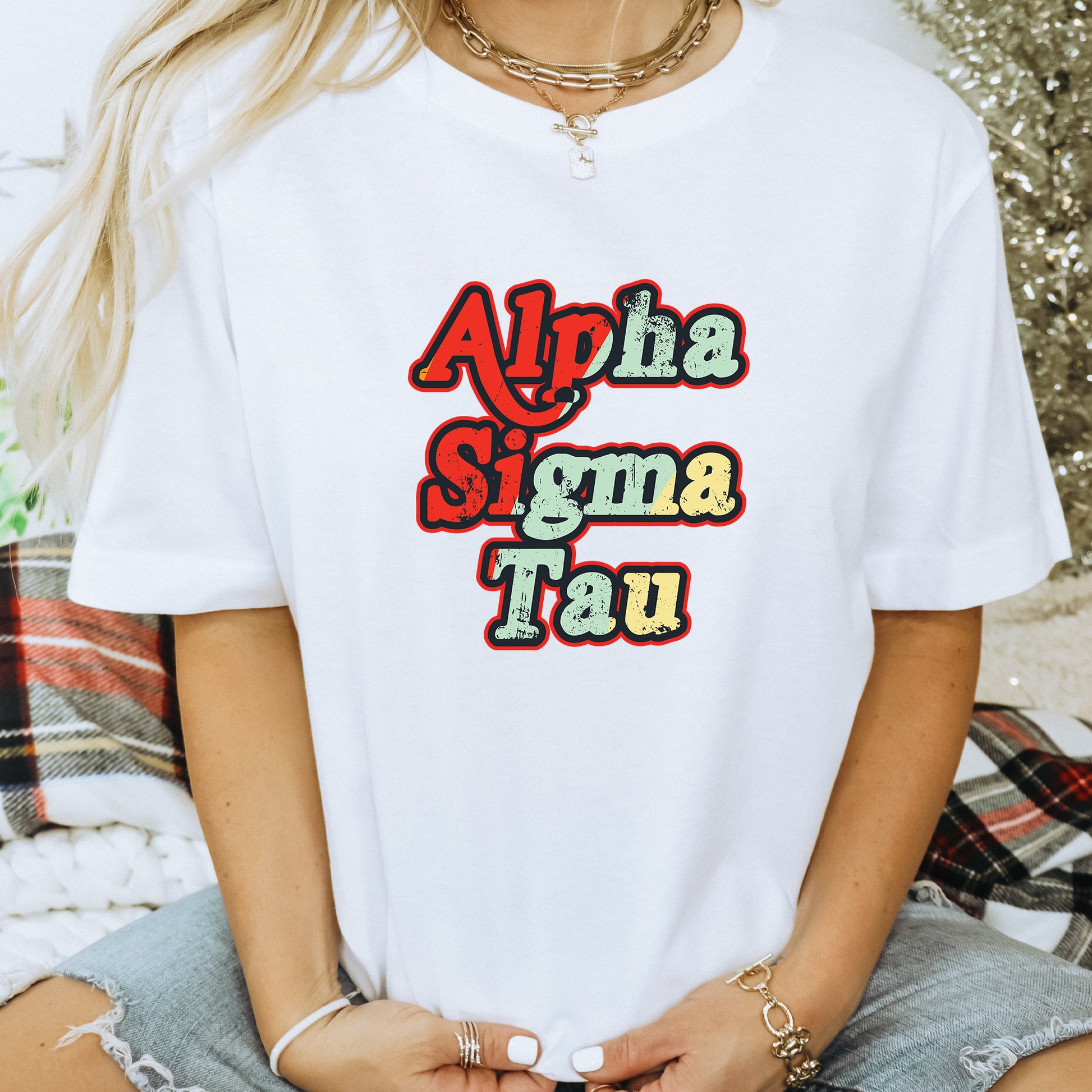 a woman wearing a white t - shirt with the words aloha stigma tau