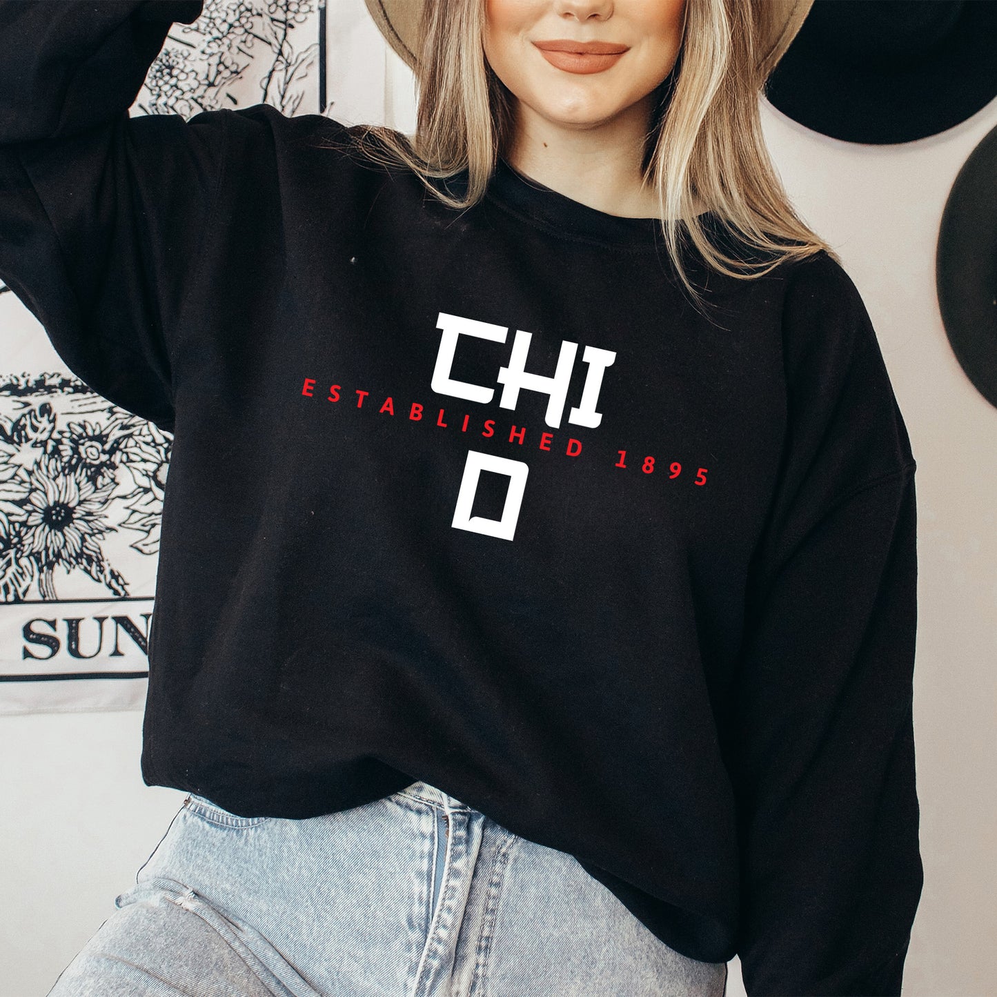 a woman wearing a black sweatshirt and hat