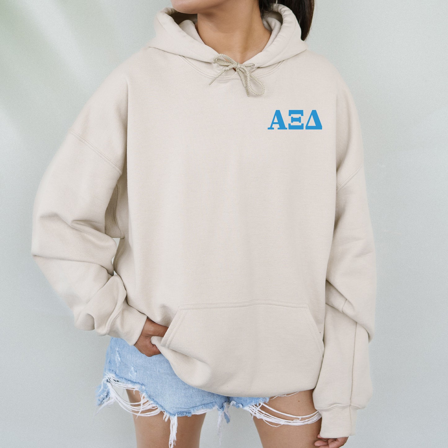 a woman wearing a hoodie with the aea logo on it