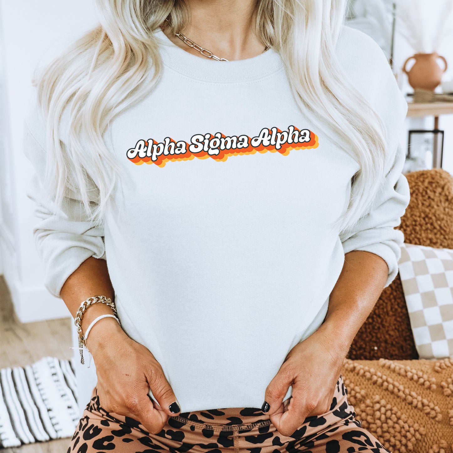 a woman wearing a white sweatshirt and leopard print pants