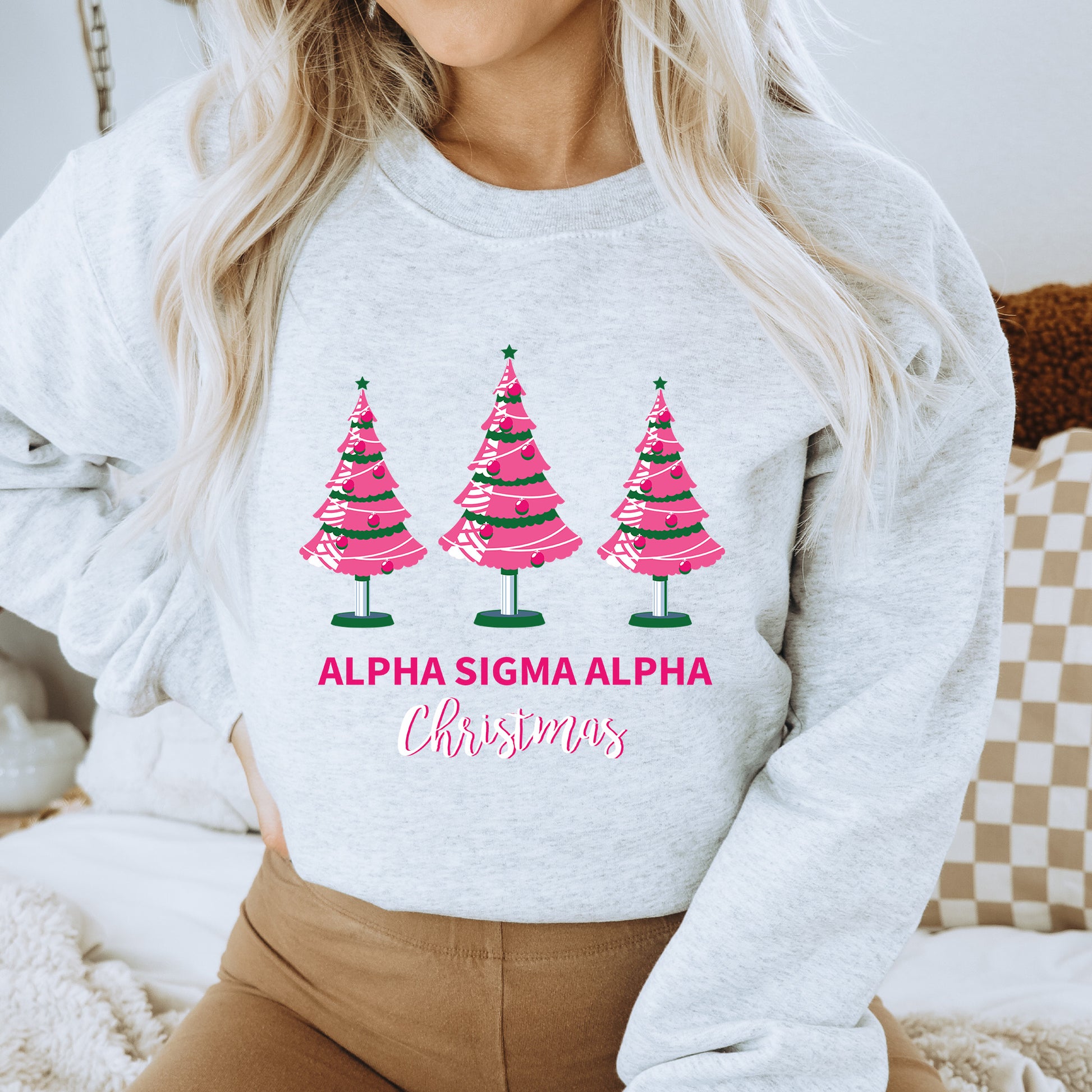 a woman wearing a sweatshirt with christmas trees on it