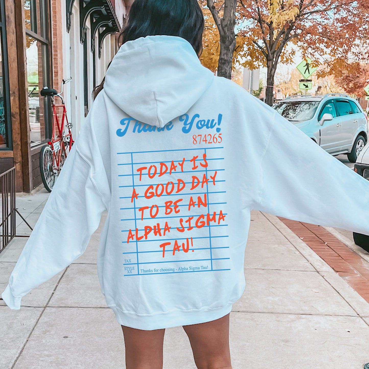 a woman in a white hoodie with writing on it