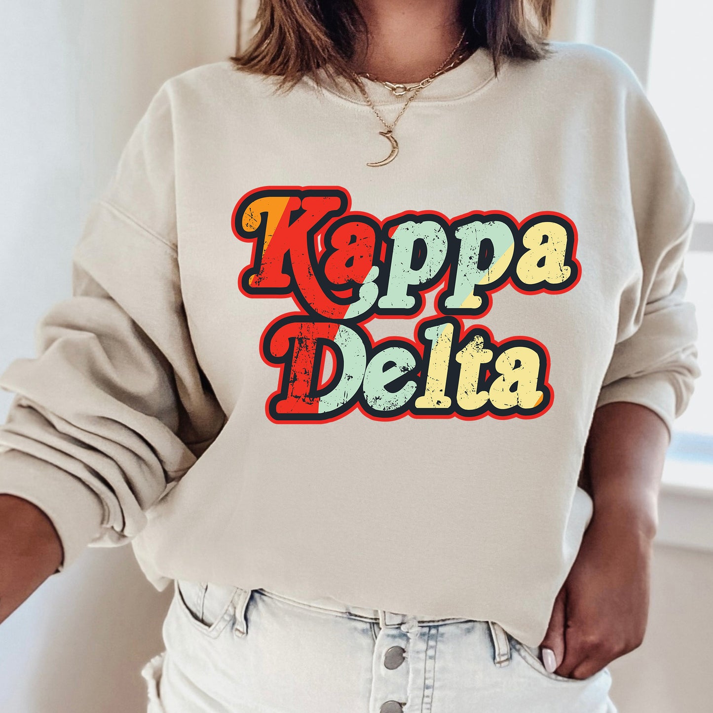 a woman wearing a sweatshirt that says kappa delta
