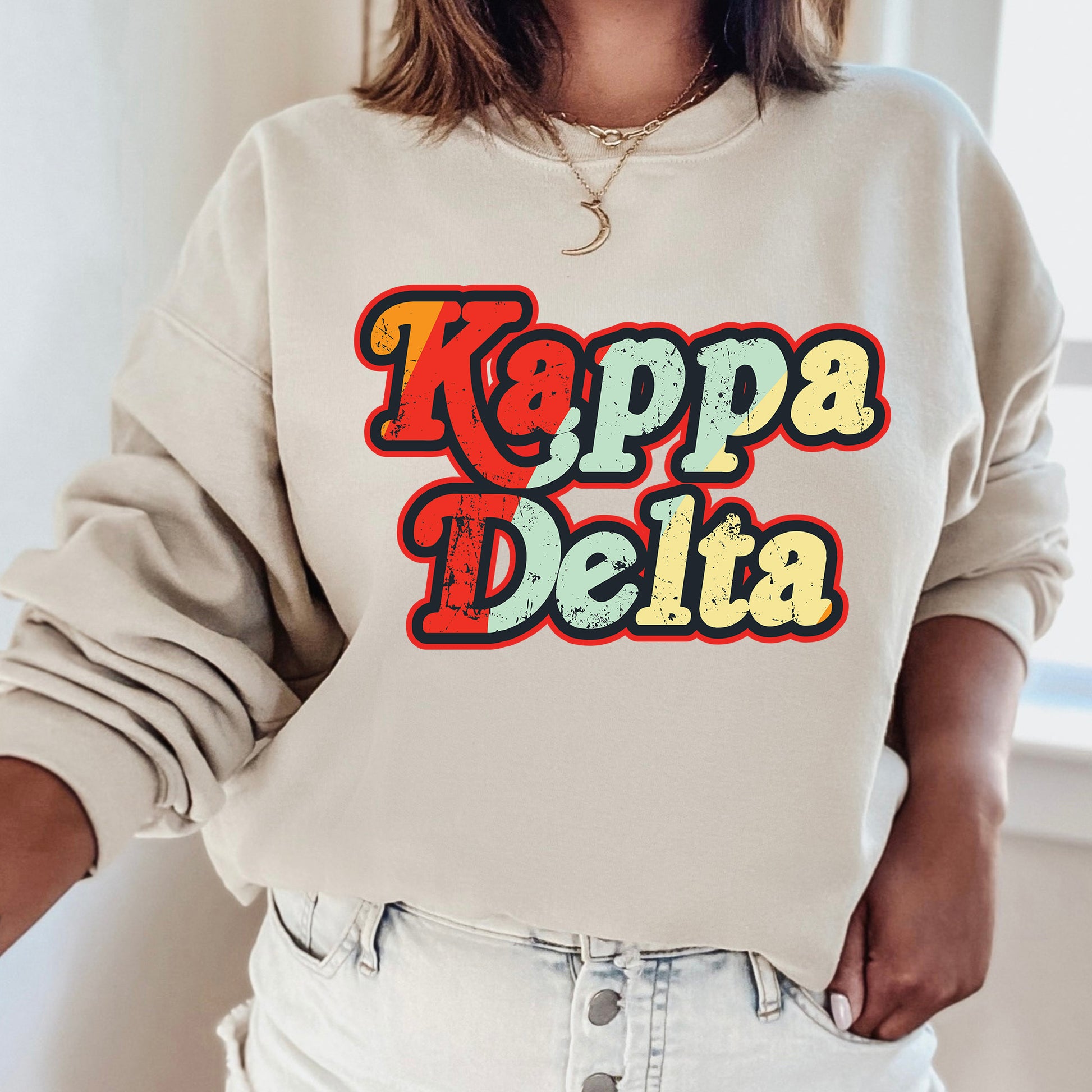 a woman wearing a sweatshirt that says kappa delta