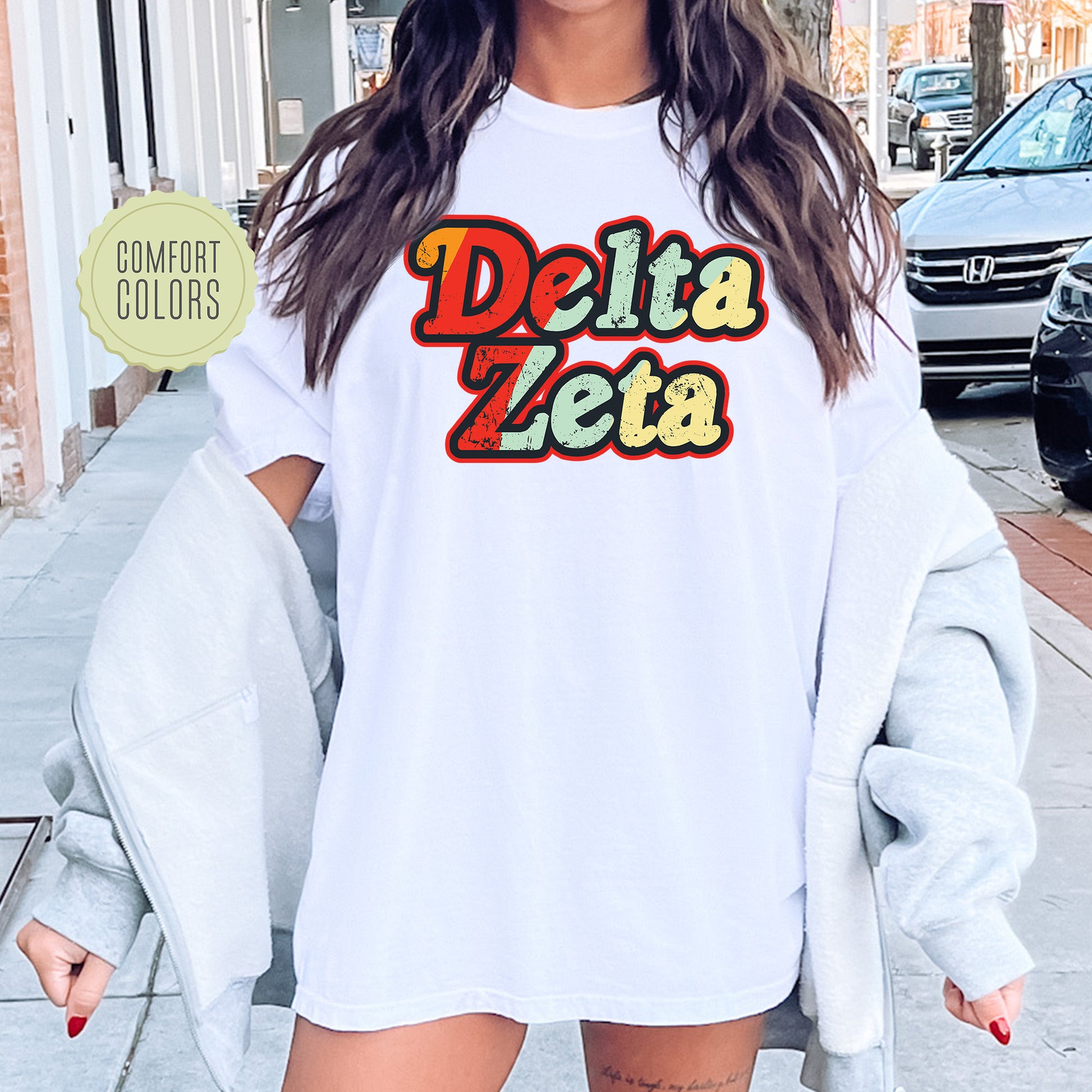 a woman wearing a white shirt with the words delta delta on it