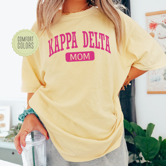 a woman in a yellow shirt holding a blender