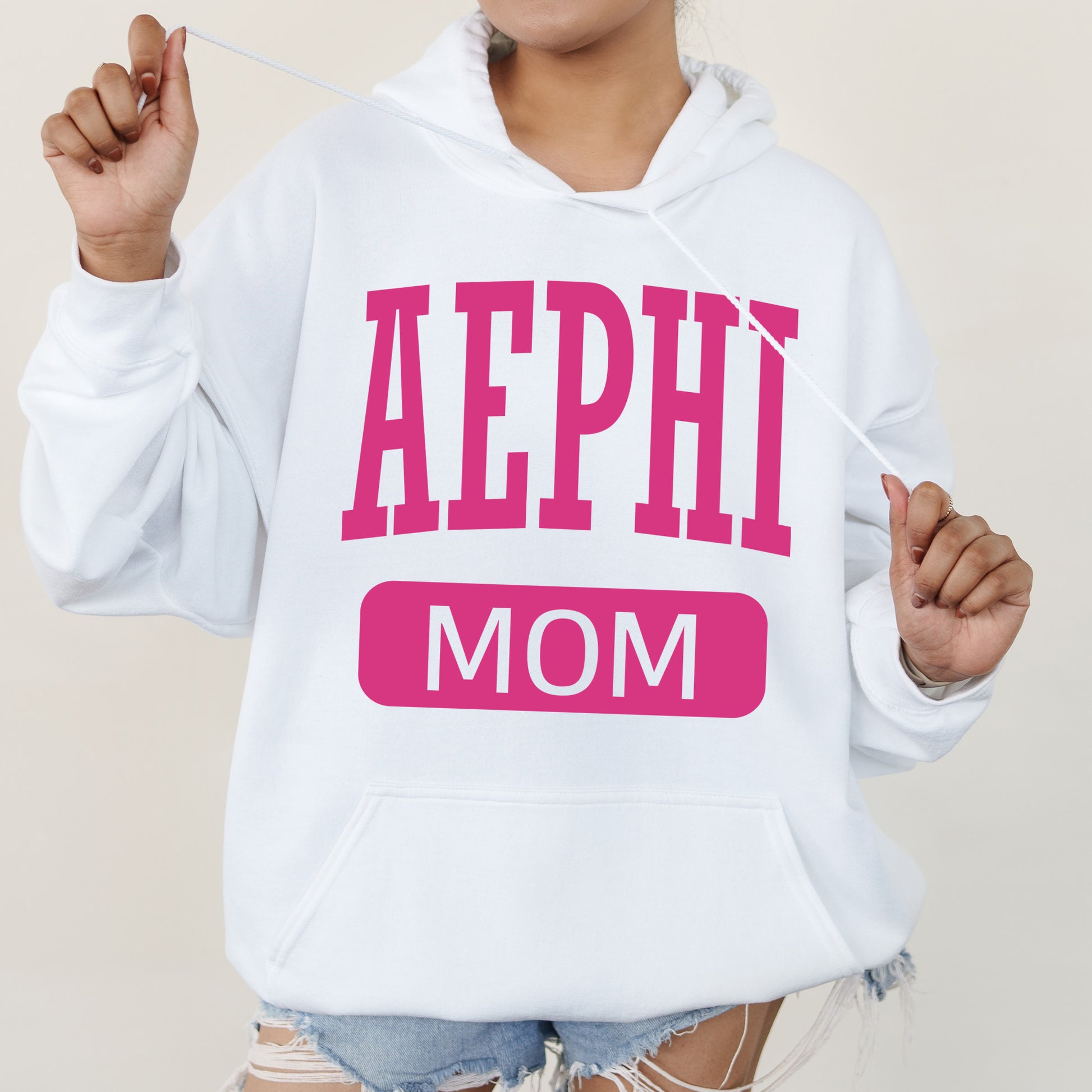 a woman wearing a white hoodie that says aephi mom