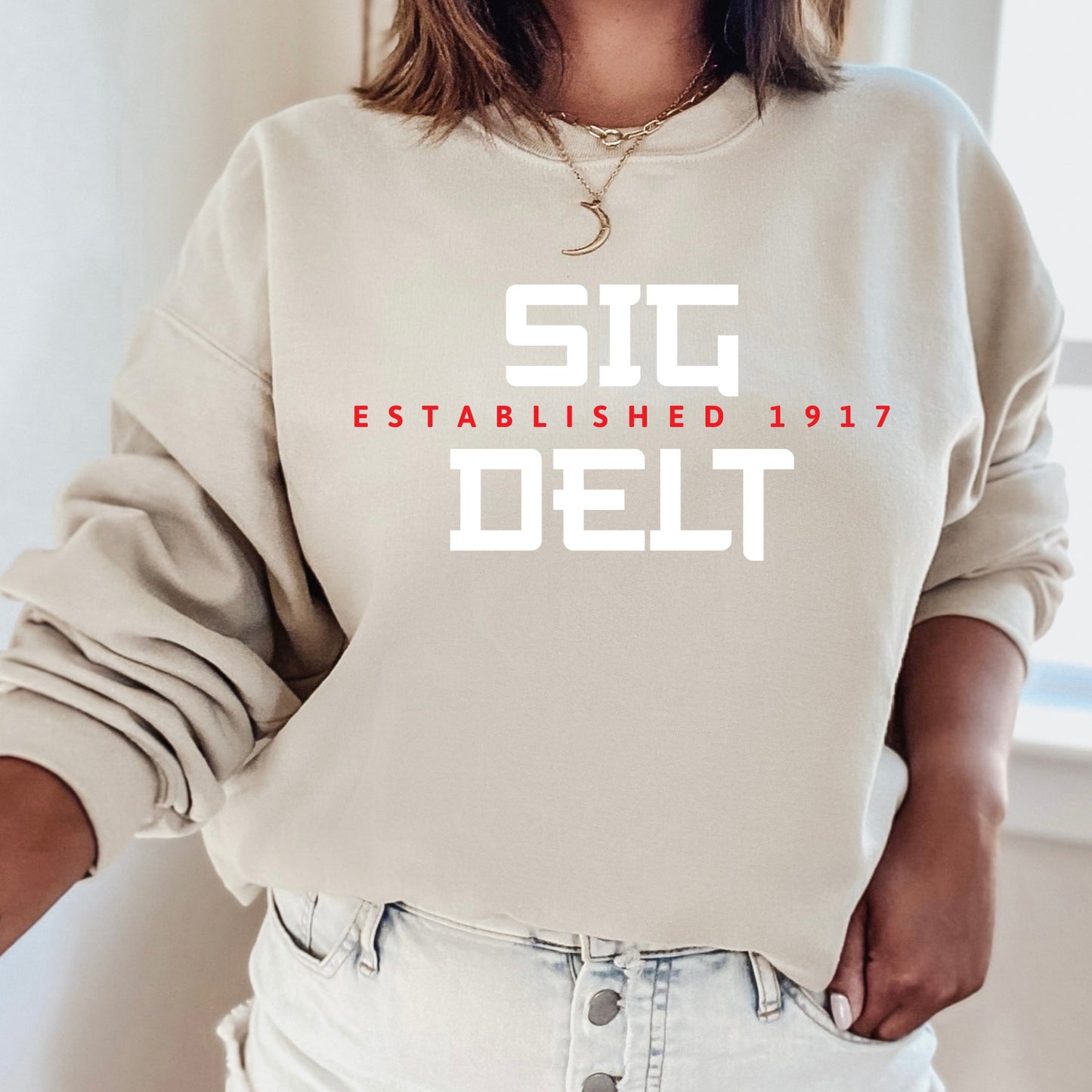 a woman wearing a sweatshirt that says stg established 1917