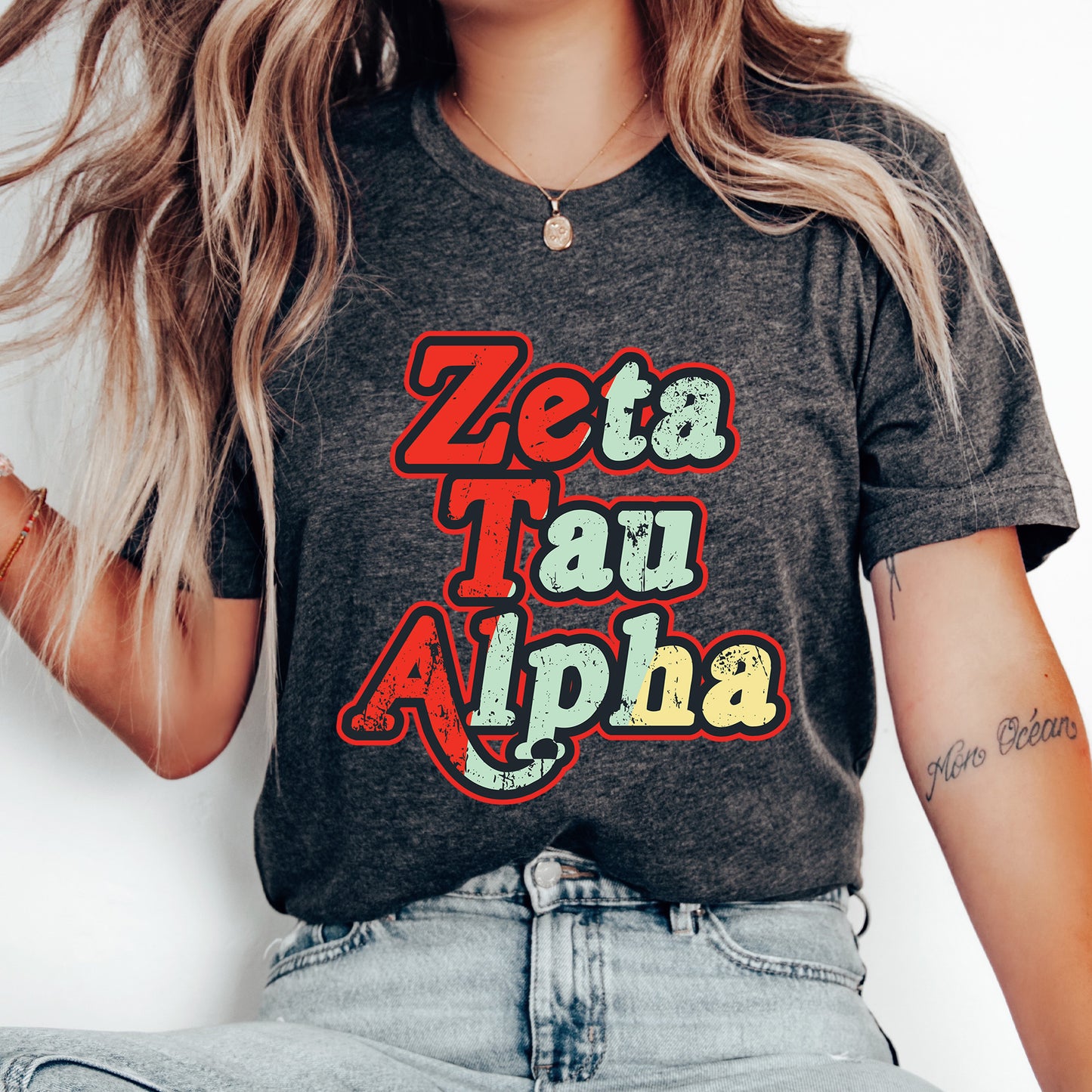 a woman wearing a t - shirt that says zeta tau alpha