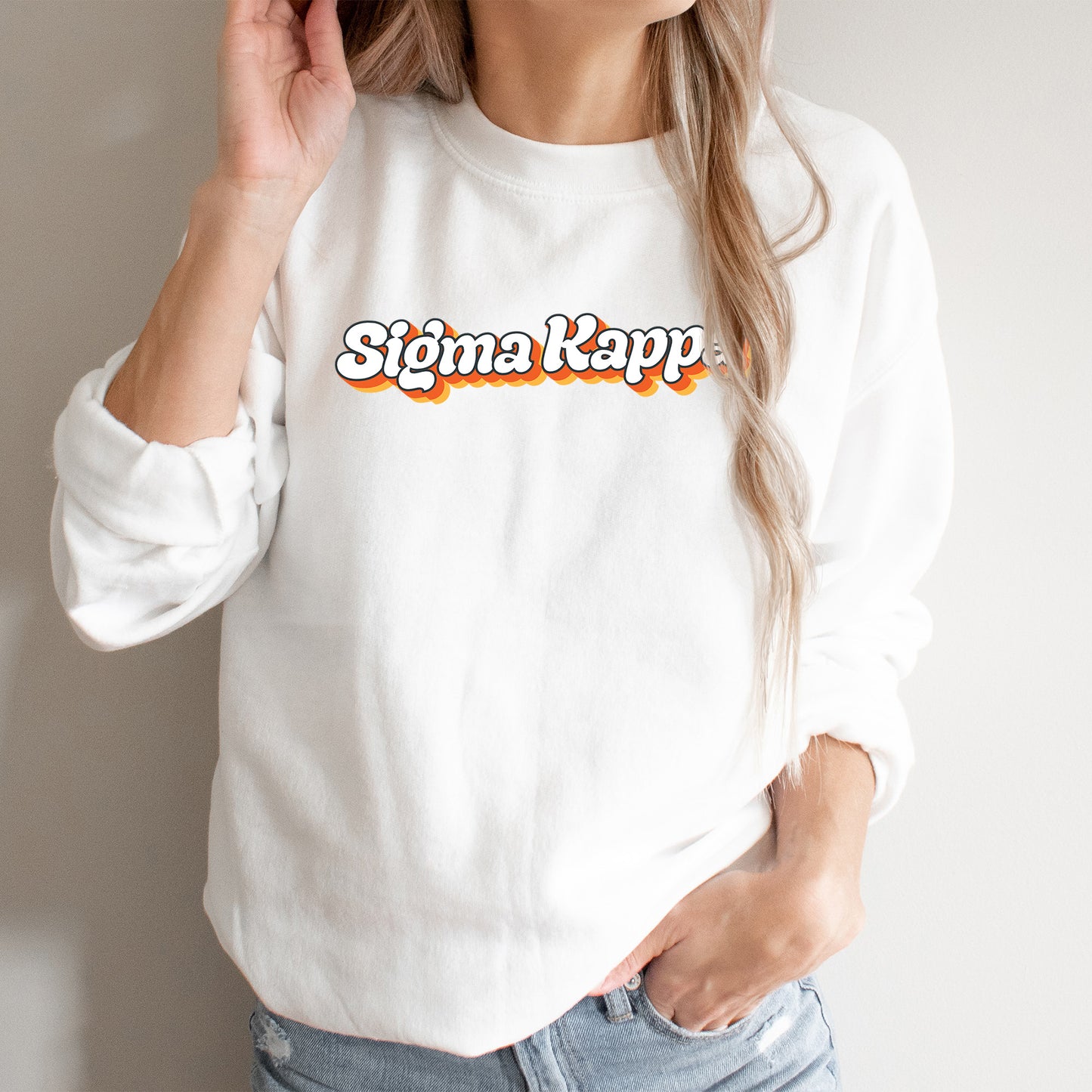 a woman wearing a white sweatshirt with the word stigma kapp on it