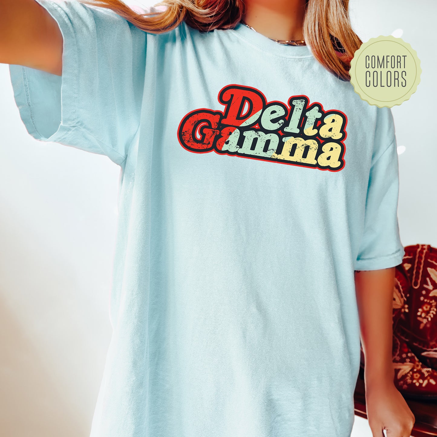 a woman wearing a blue shirt with the words delta gumma on it