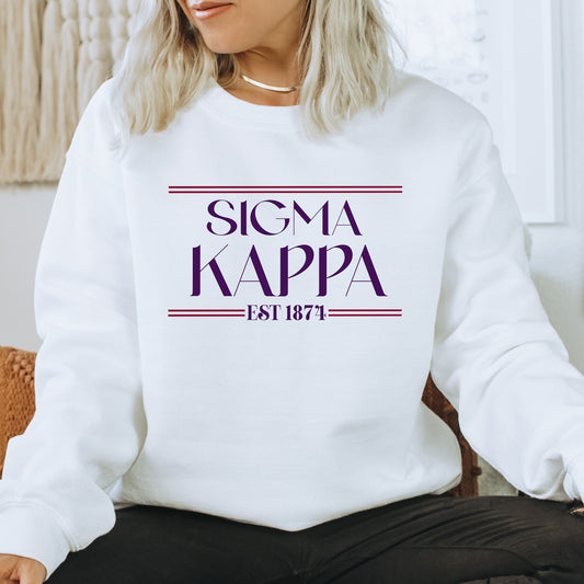 a woman sitting on a chair wearing a white sweatshirt