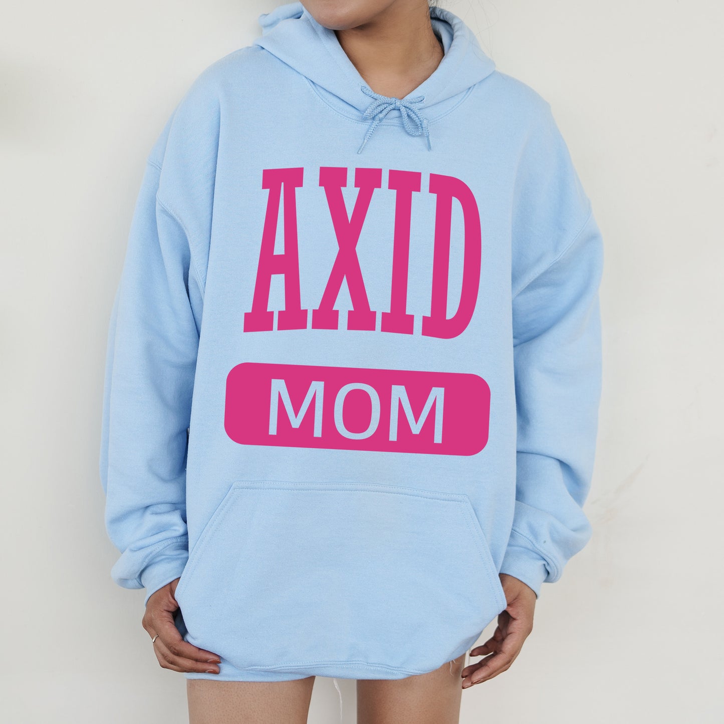 a woman wearing a blue hoodie that says axd mom