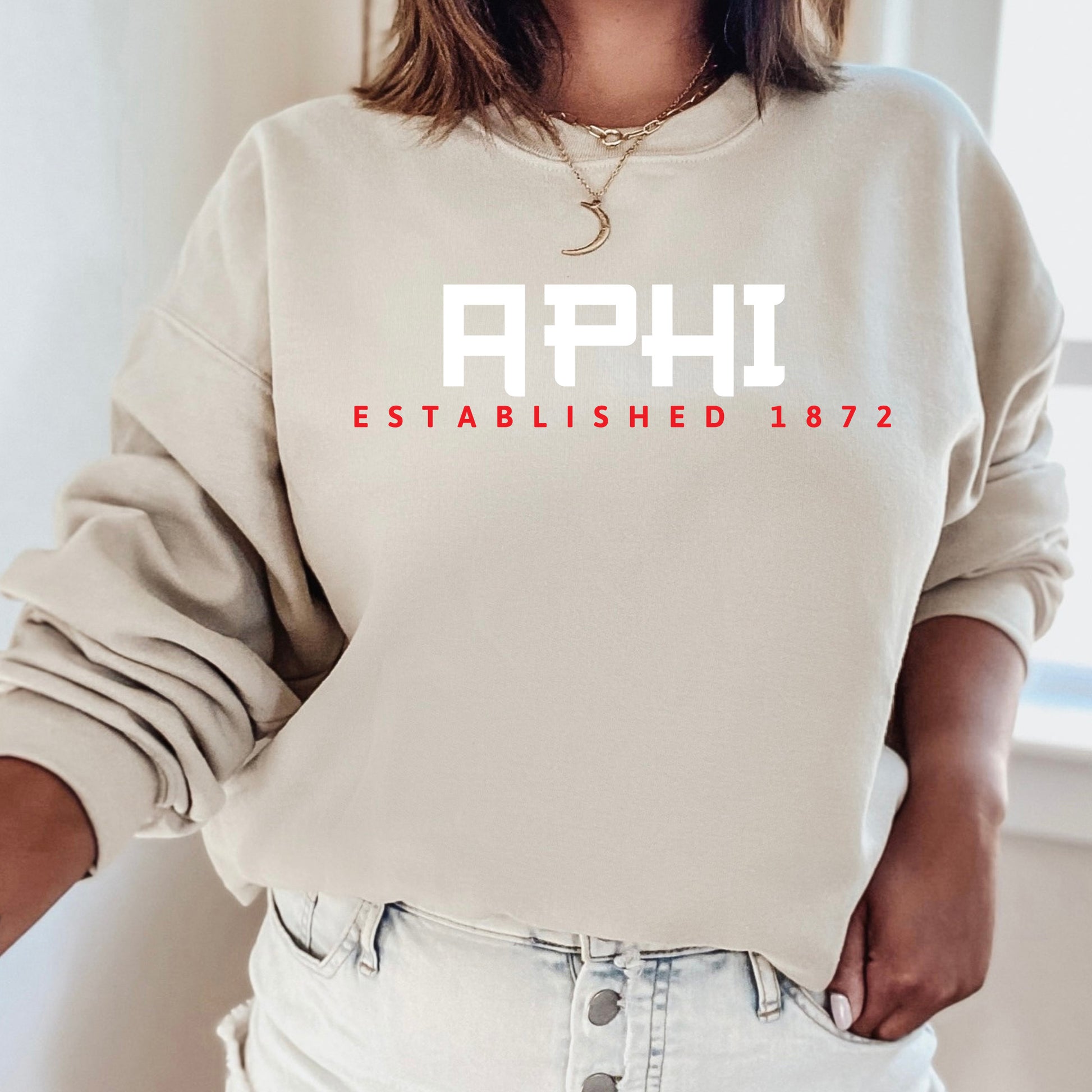 a woman wearing a sweatshirt with the word aphi on it