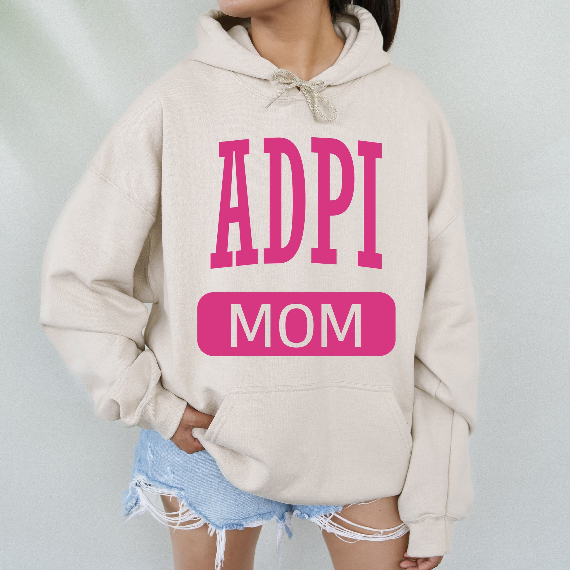 a woman wearing a sweatshirt that says appi mom