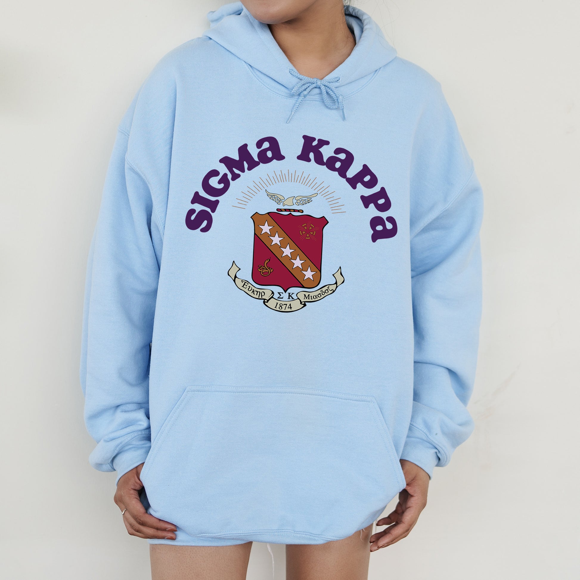 a person wearing a blue hoodie with a crest on it