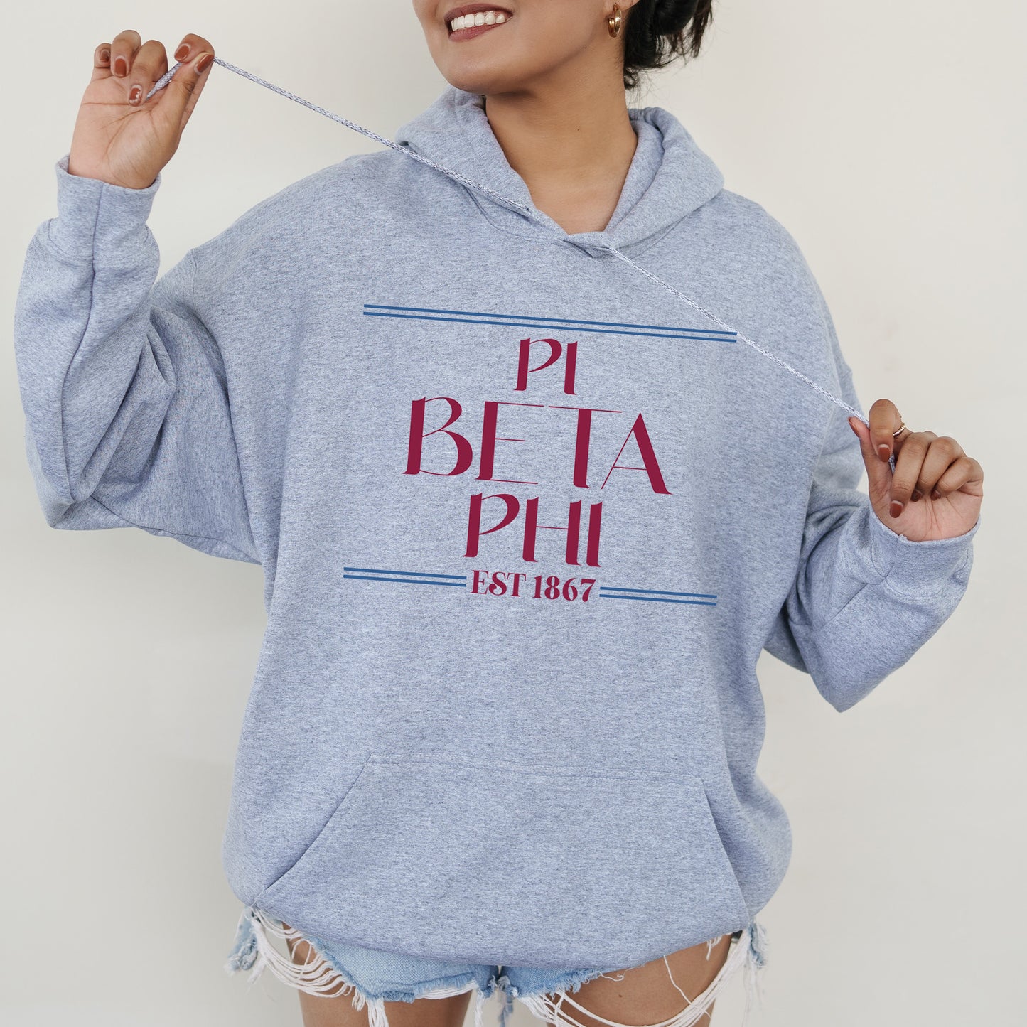 a woman in a blue hoodie holding a toothbrush
