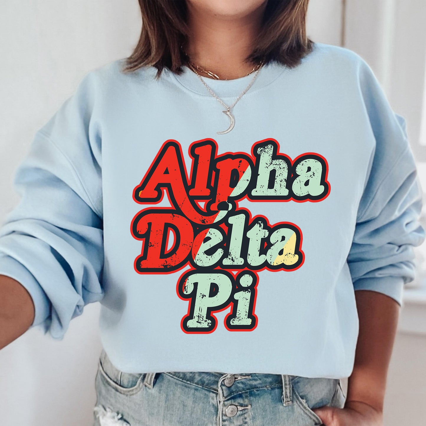 a woman wearing a blue sweatshirt that says aloh delta pi
