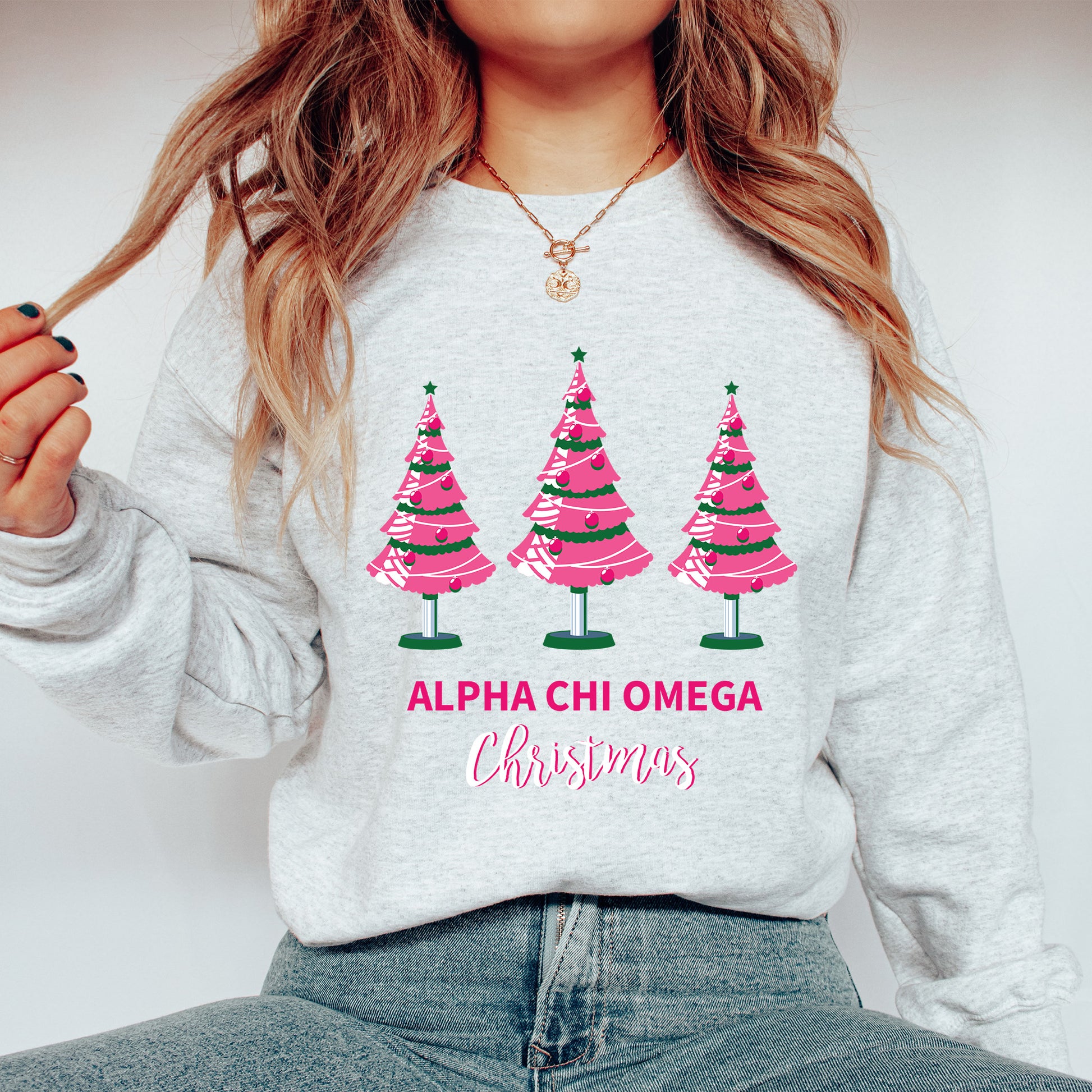 a woman wearing a sweatshirt with christmas trees on it