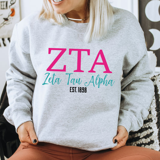 a woman sitting on a chair wearing a sweatshirt