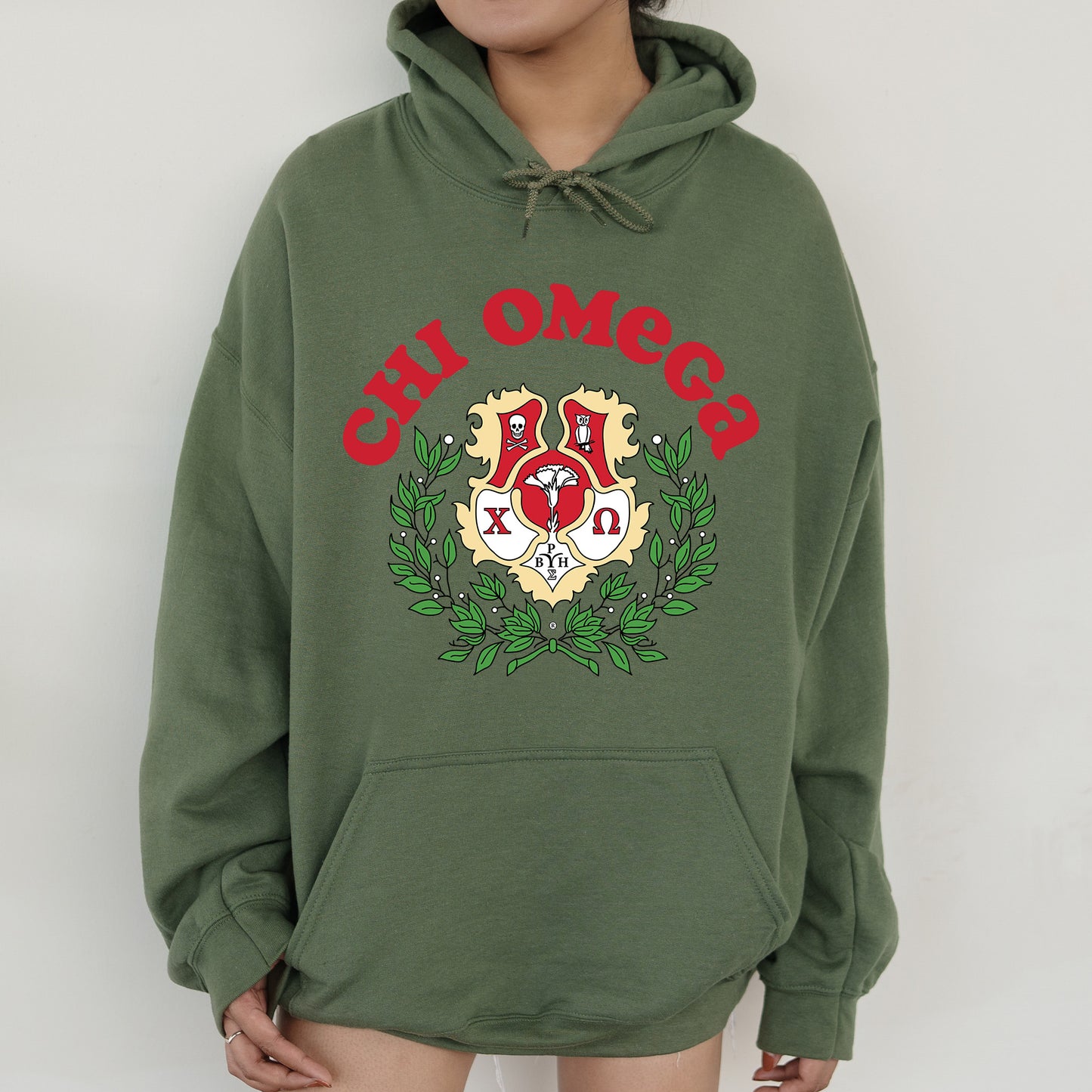 a person wearing a green hoodie with a red and white logo on it