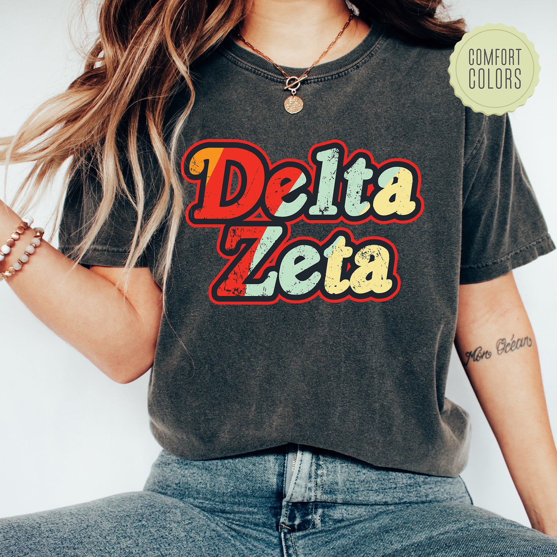 a woman wearing a black delta zeta t - shirt