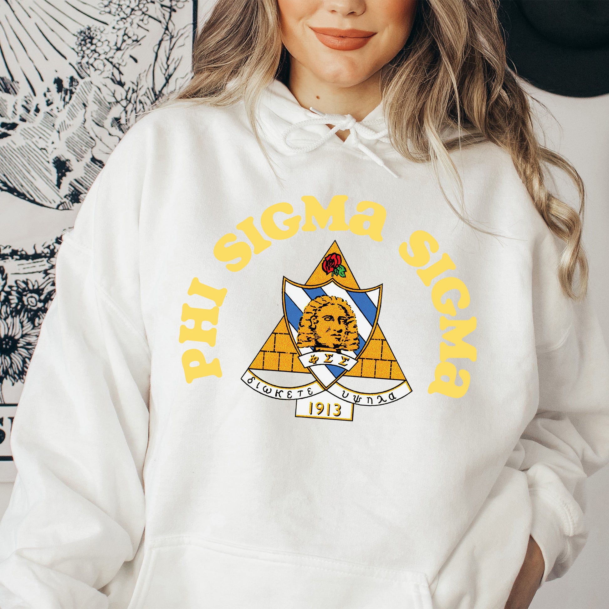 a woman wearing a white hoodie with an emblem on it
