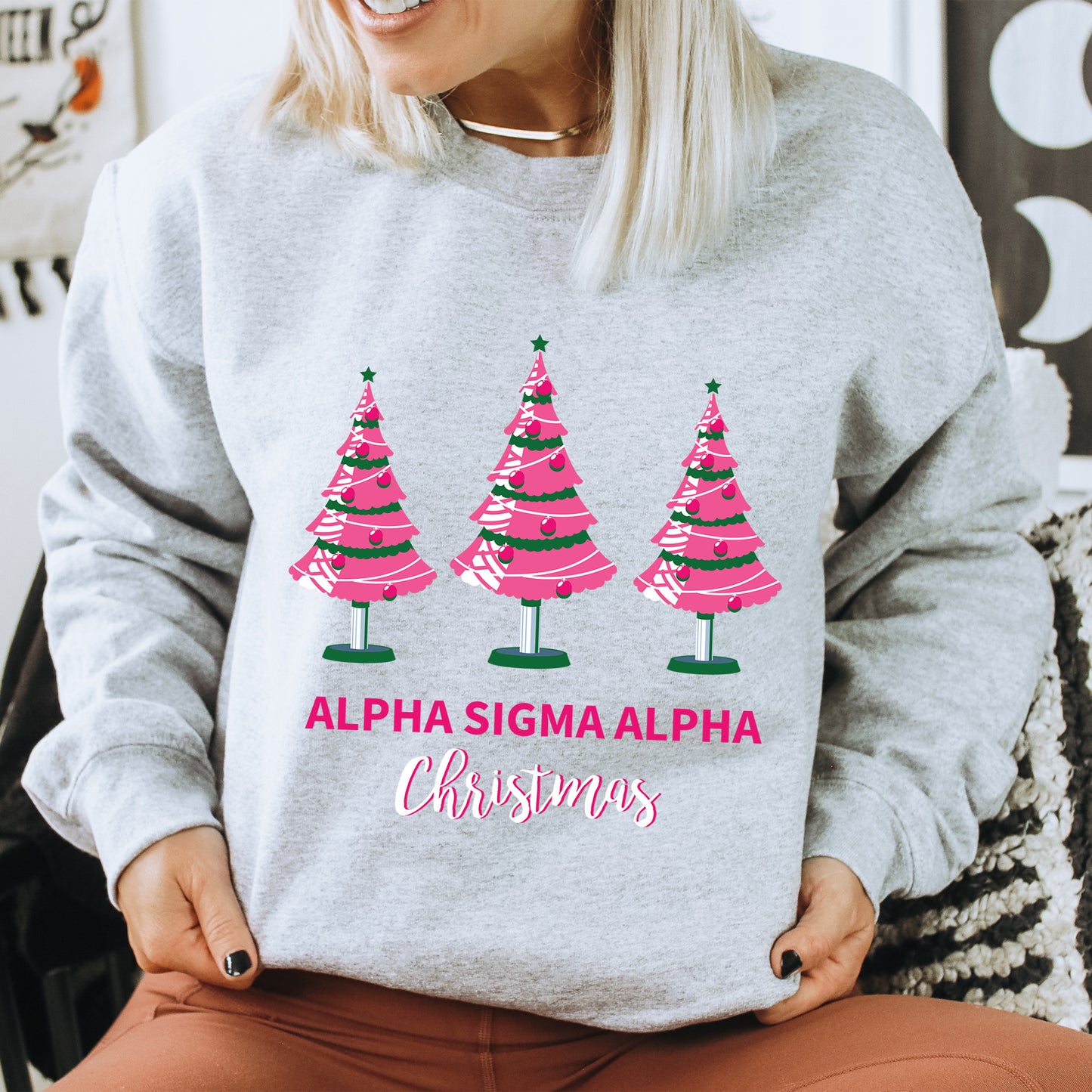 a woman wearing a sweatshirt with christmas trees on it