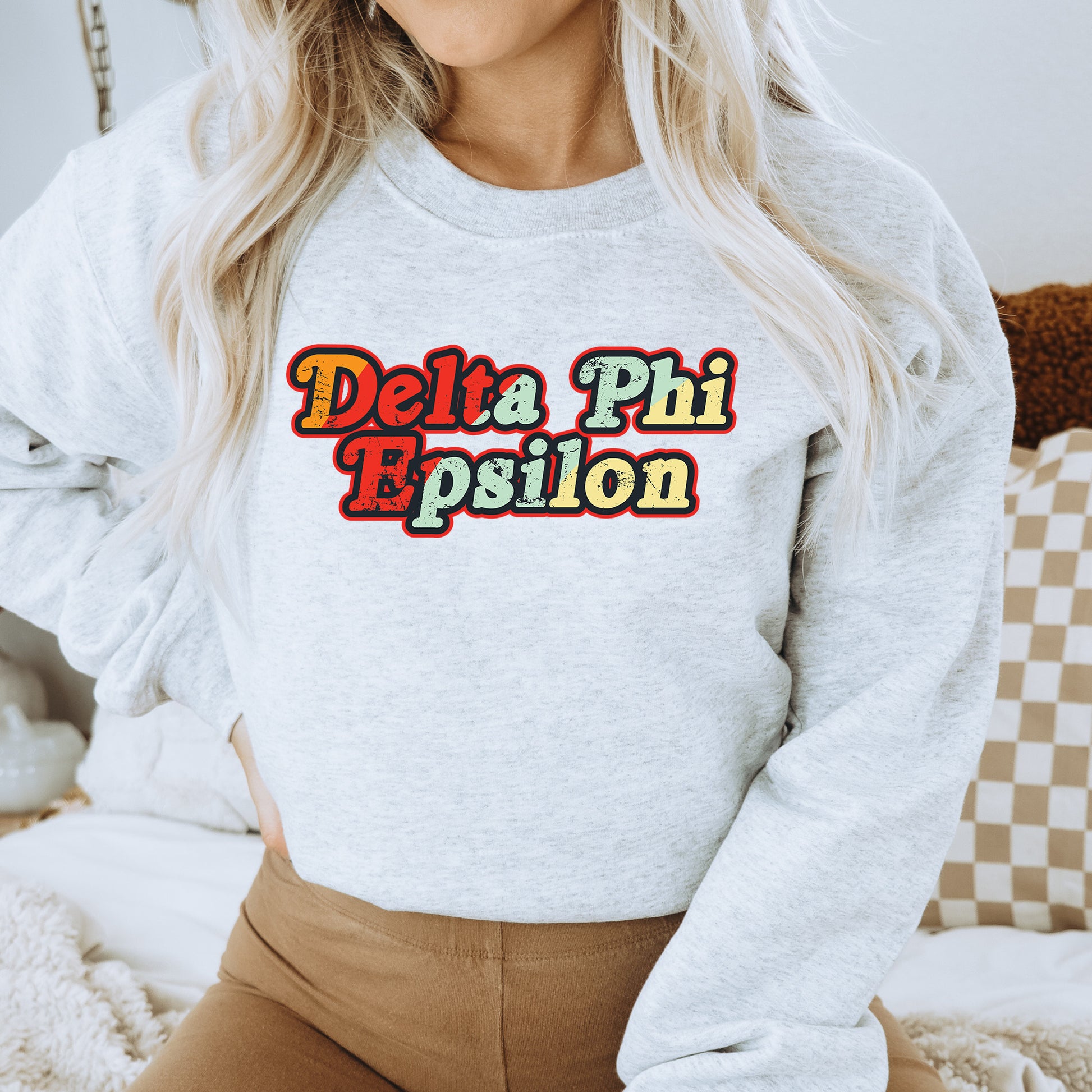 a woman wearing a sweatshirt that says delta phi prison