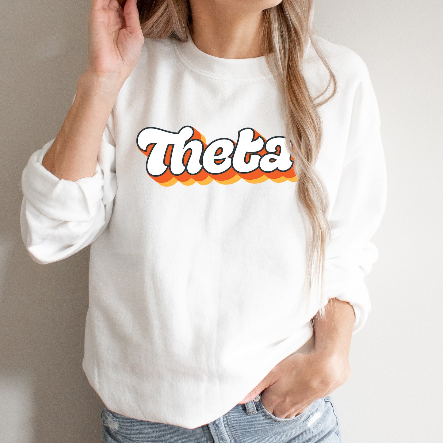 a woman wearing a white sweatshirt with the word thea printed on it