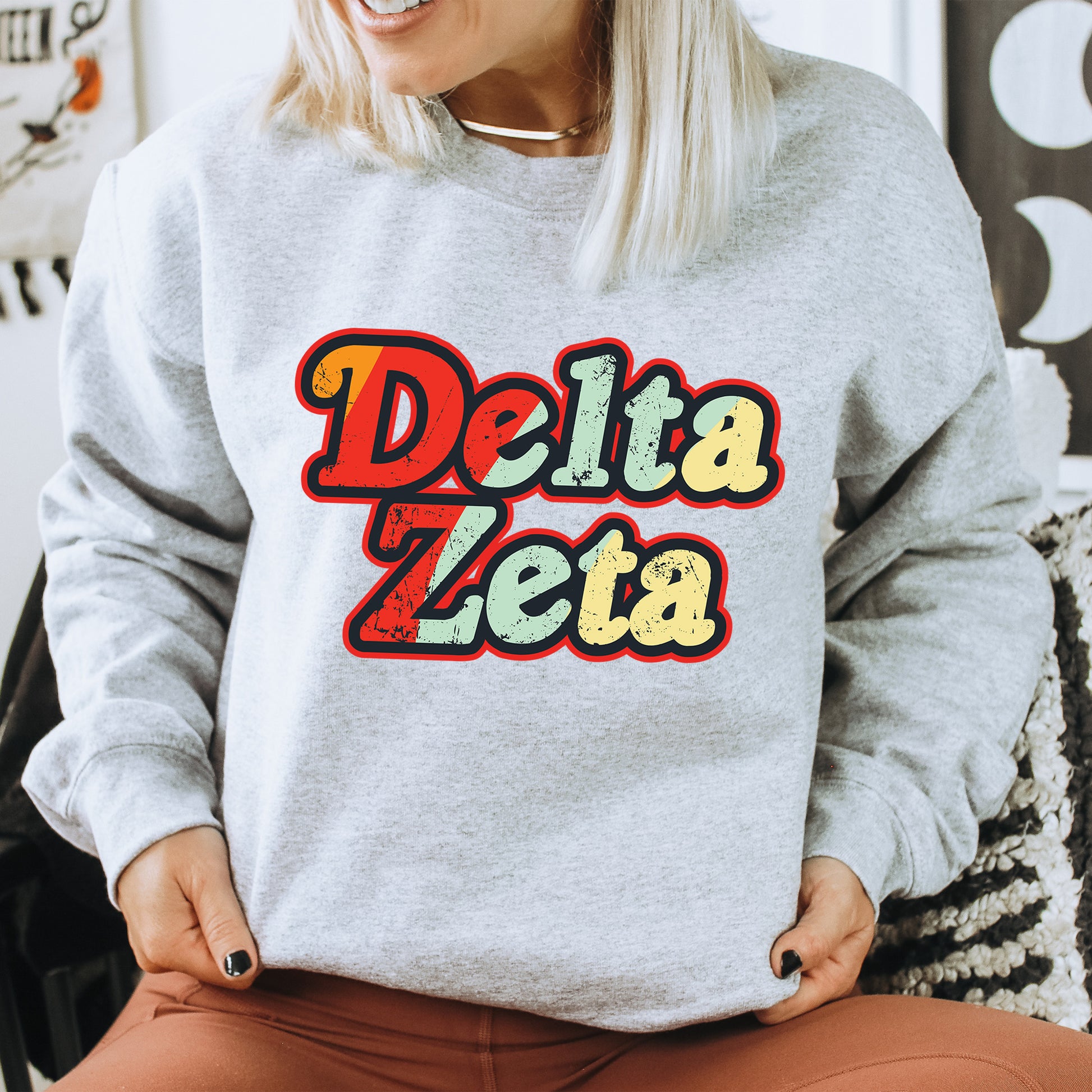 a woman wearing a sweatshirt that says delta zeta
