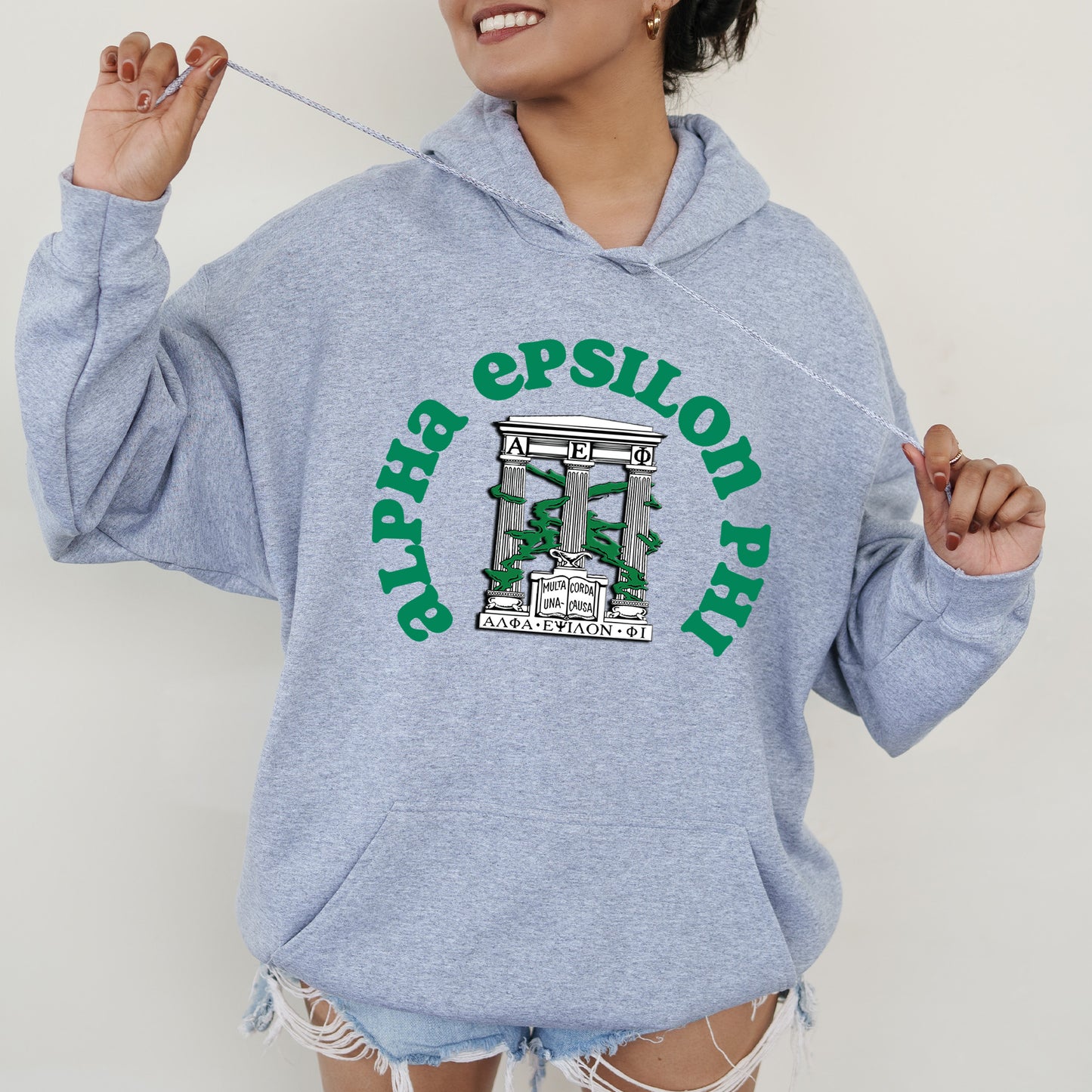 a woman in a blue hoodie holding a toothbrush