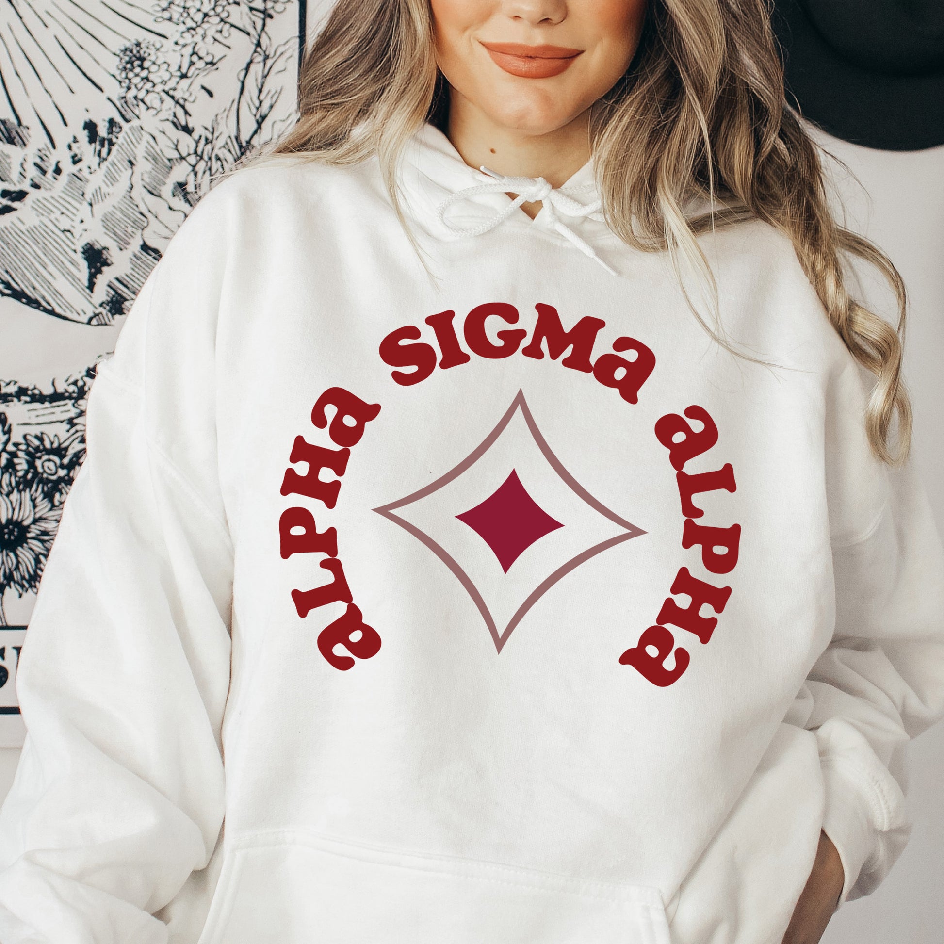 a woman wearing a white sweatshirt with a red and white graphic on it