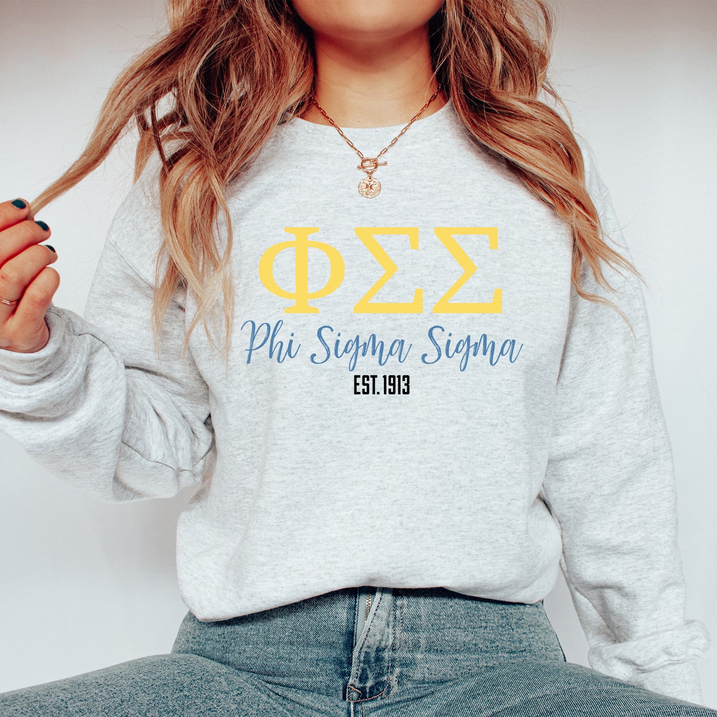 a woman wearing a phi phi phi sweatshirt