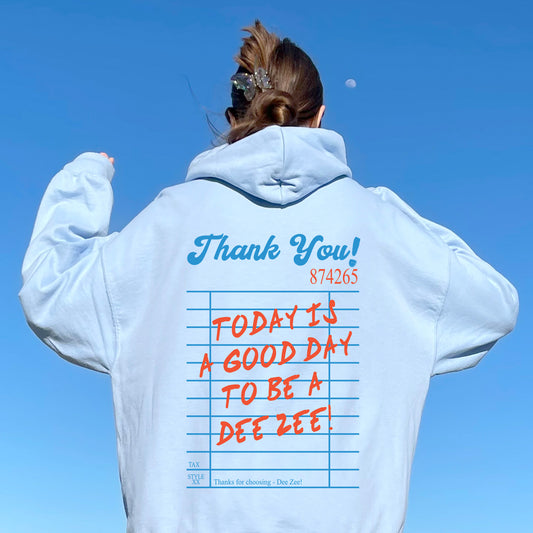 a woman wearing a white hoodie with writing on it