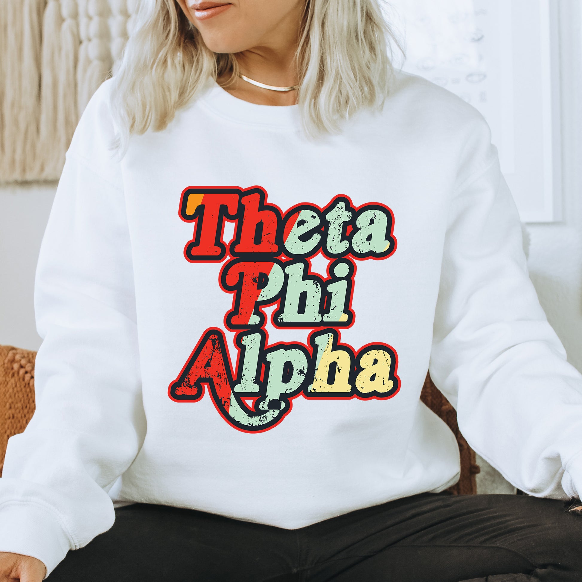 a woman sitting on a chair wearing a white sweatshirt