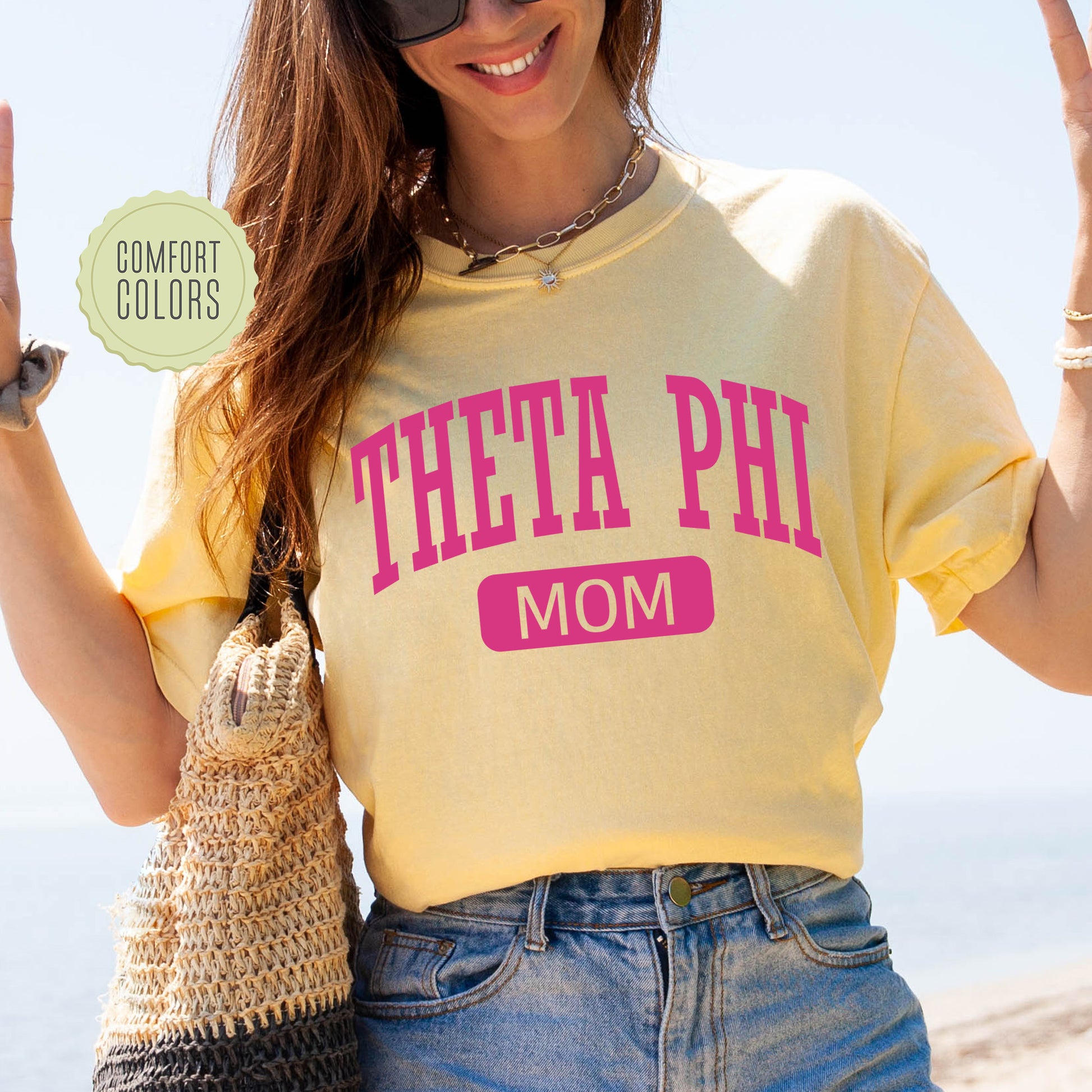 a woman in a yellow shirt is holding up a peace sign